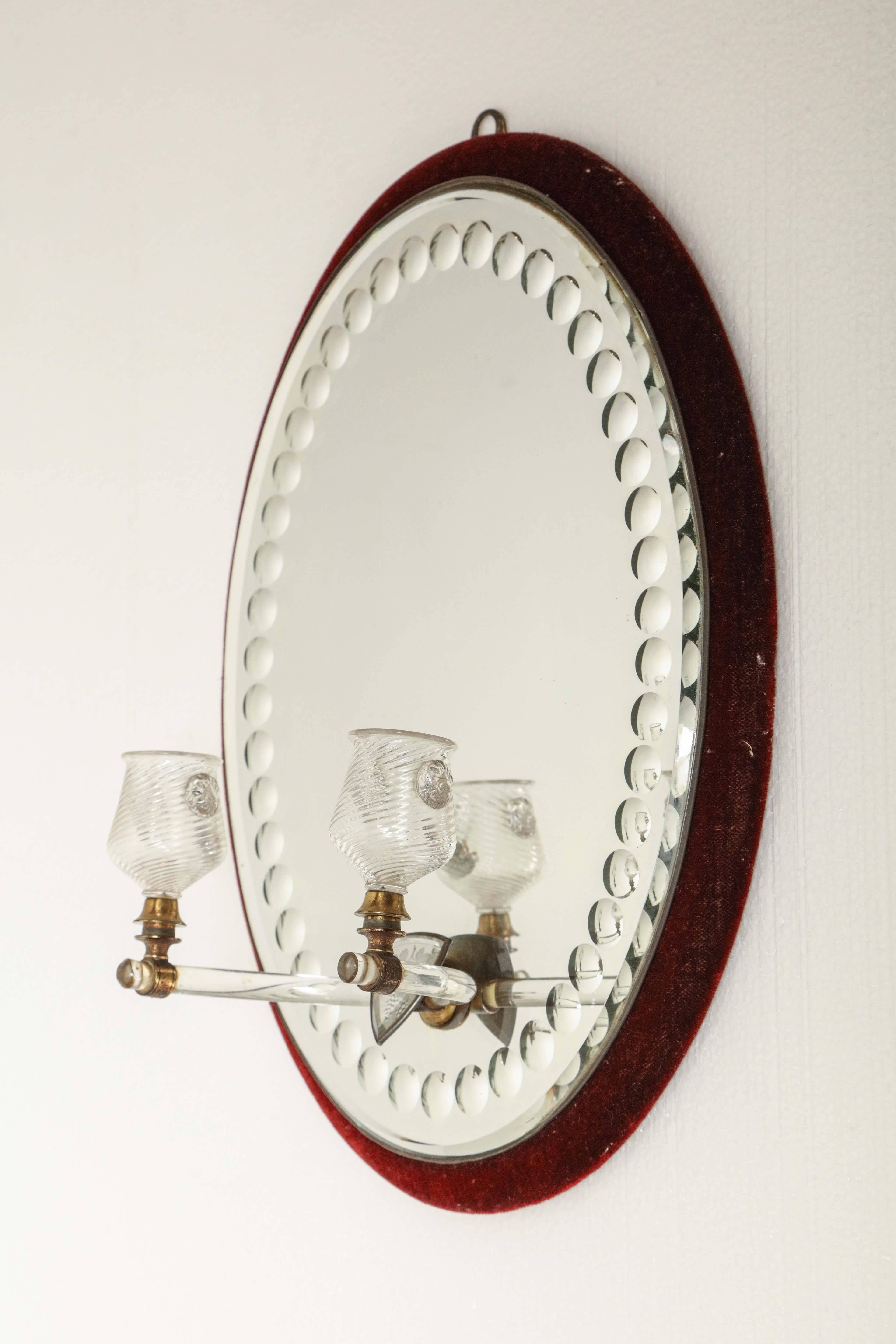 Mid-19th century mirror with plush covered frame.