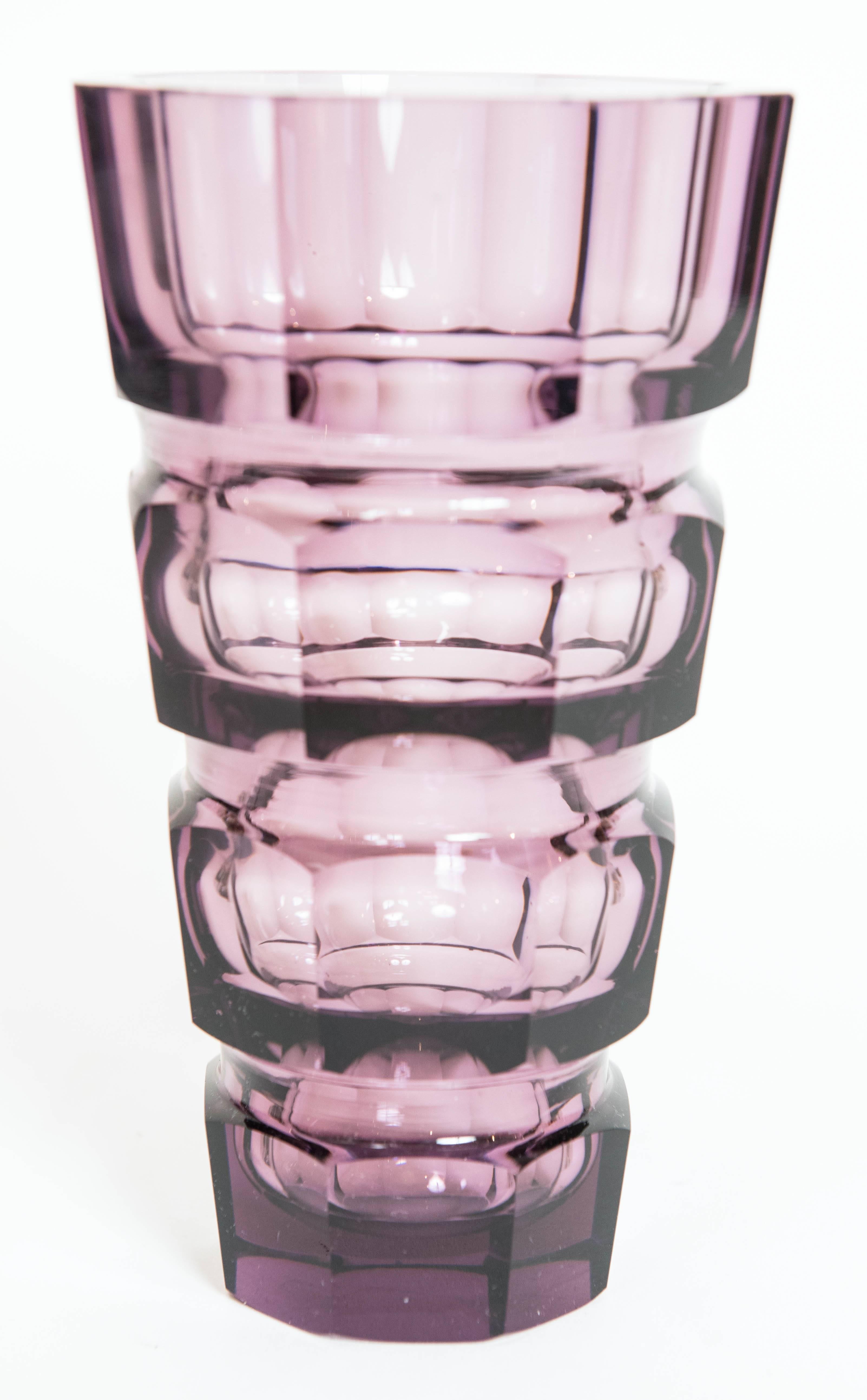 A stunning crystal vase in a deep amethyst colour by luxury European
glass manufacture Moser Glassworks.