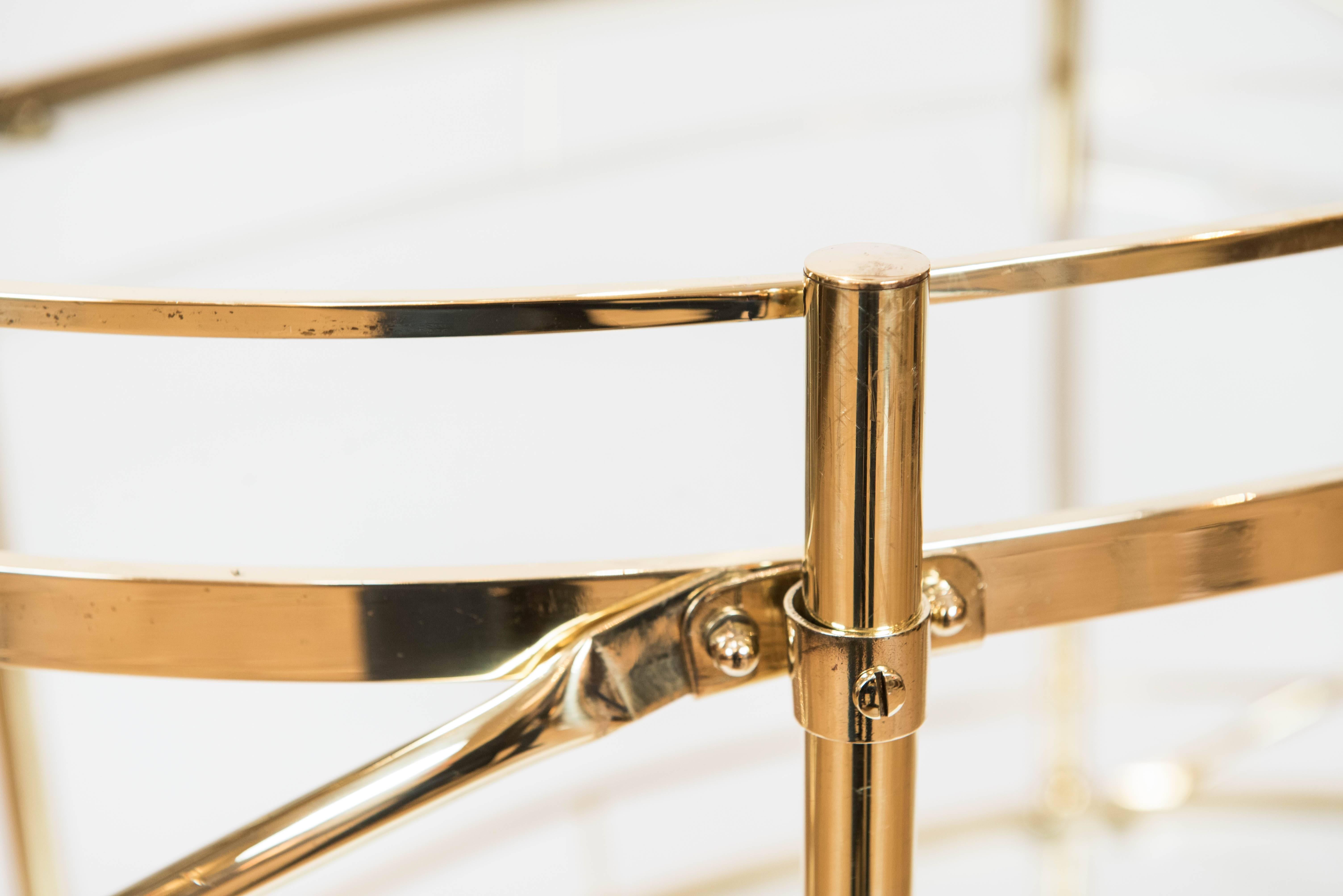 This elegant and unique solid brass bar cart with hard acrylic castors exudes
style and opulence. It has been polished to a new shine but it will age gracefully with time.