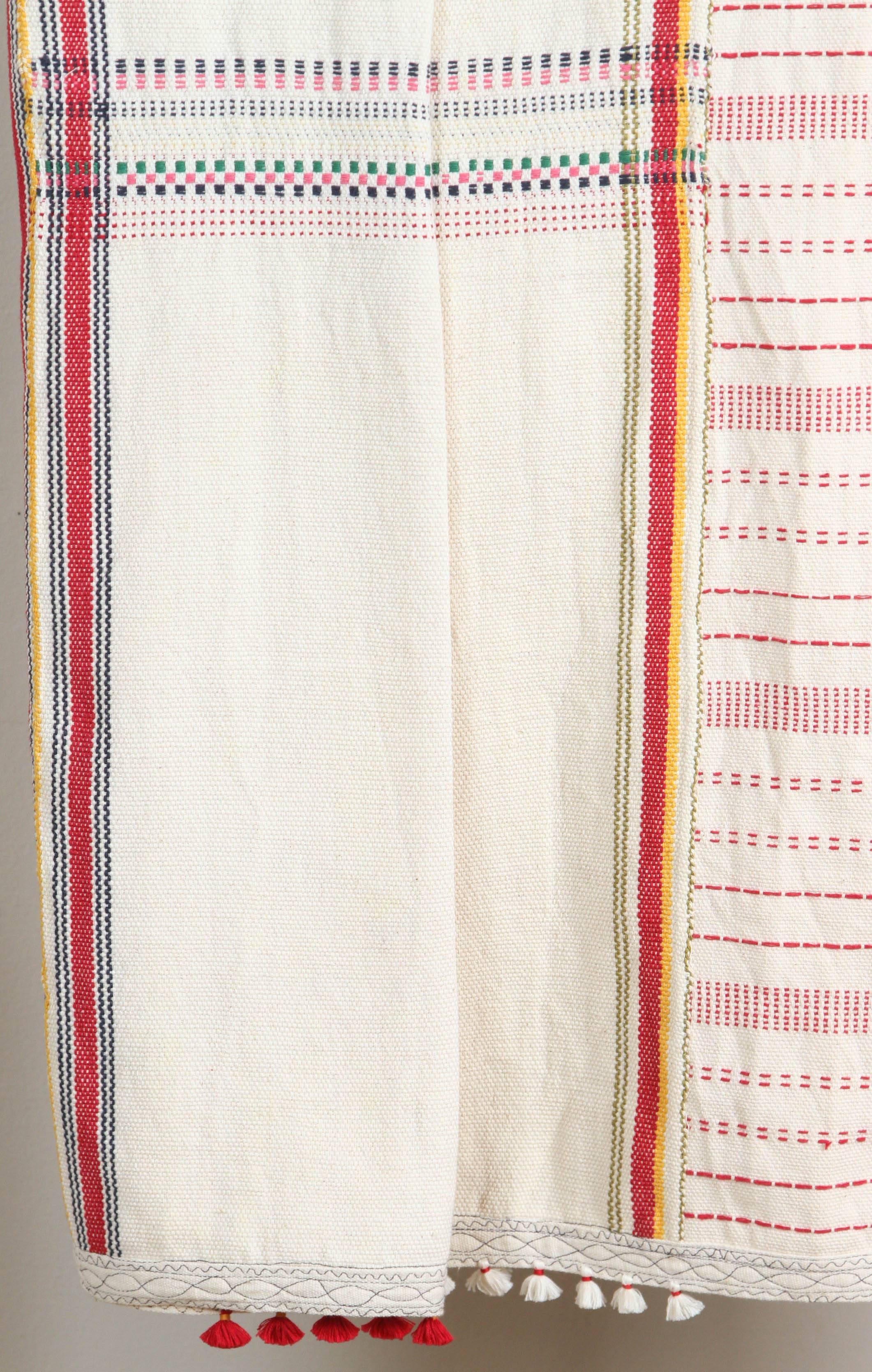Kala naturally dyed organic cotton from Gujarat, India.  Hand loomed using traditional Indian textile techniques to produce extra weft woven stripes and geometric designs.  Ivory, red, pink, blue, yellow and green. Some embroidery and added red and
