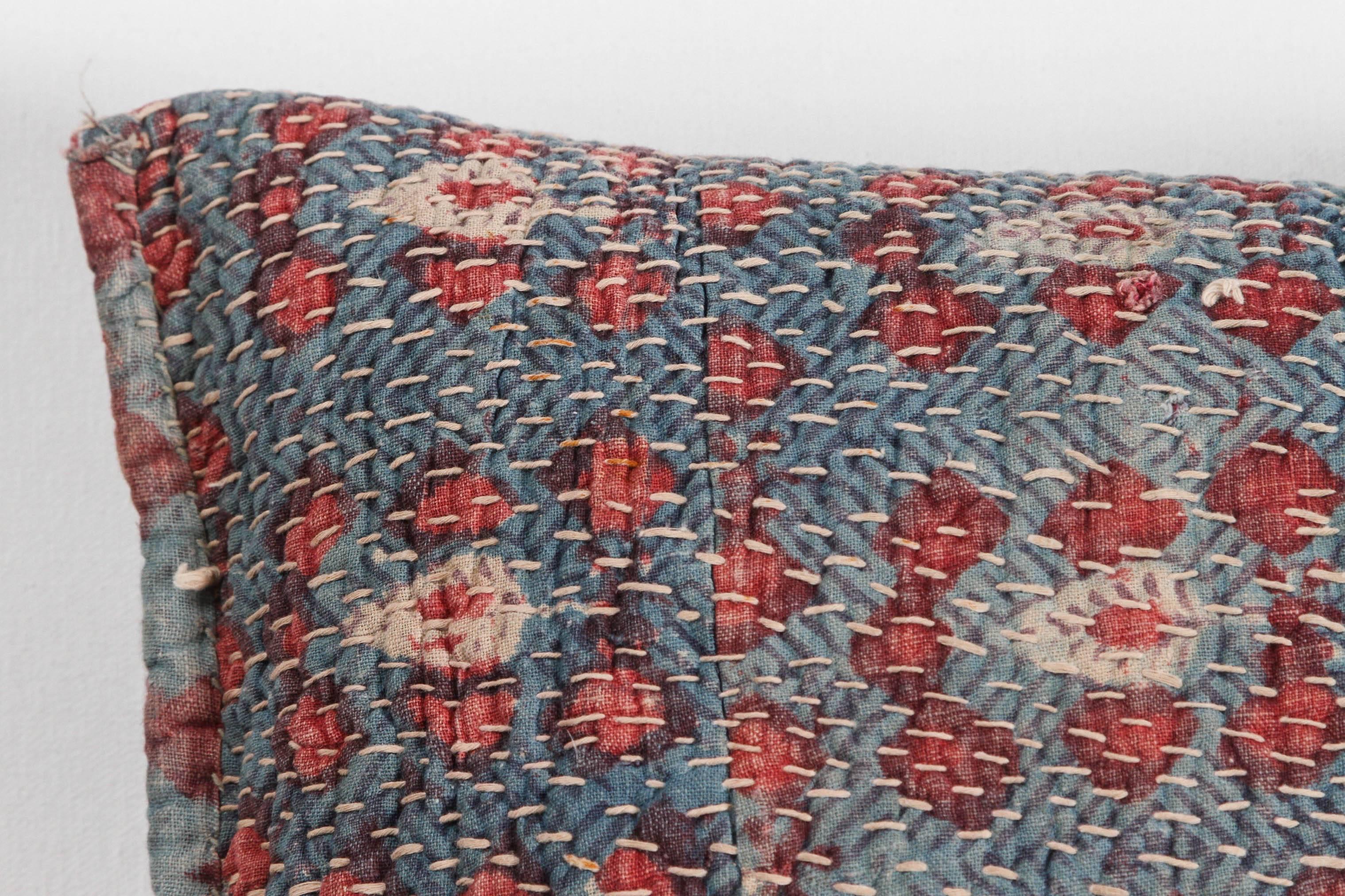 North Indian quilted storage bag made into a two-sided pillow or cushion. Vintage floral cotton block printed textile with hand quilting stitches. Blue, red, ivory. Zipper added. Feather and down fill.