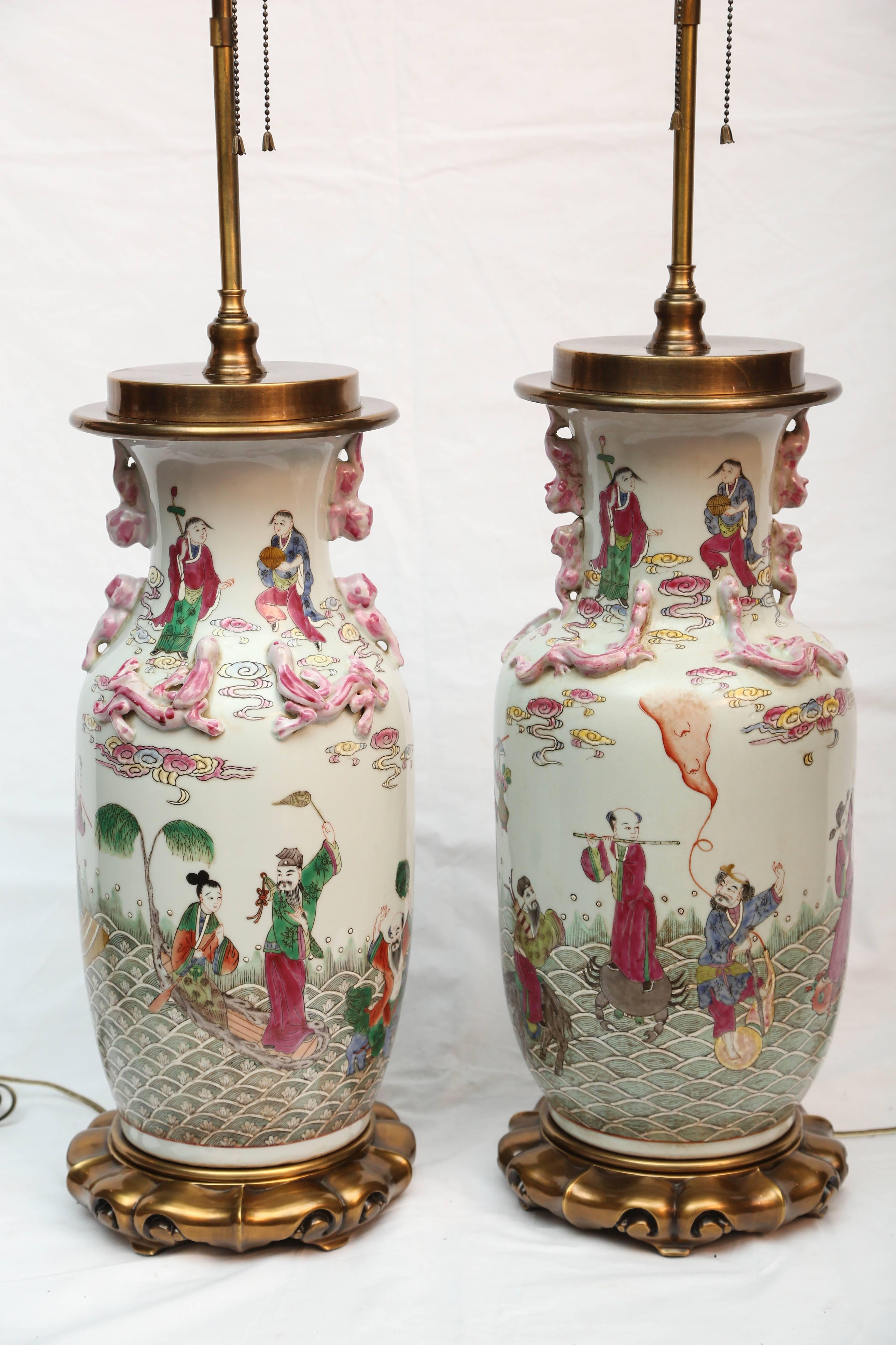 Hand-painted with detailed figures and beautifully scaled. The mounted vases are 24
