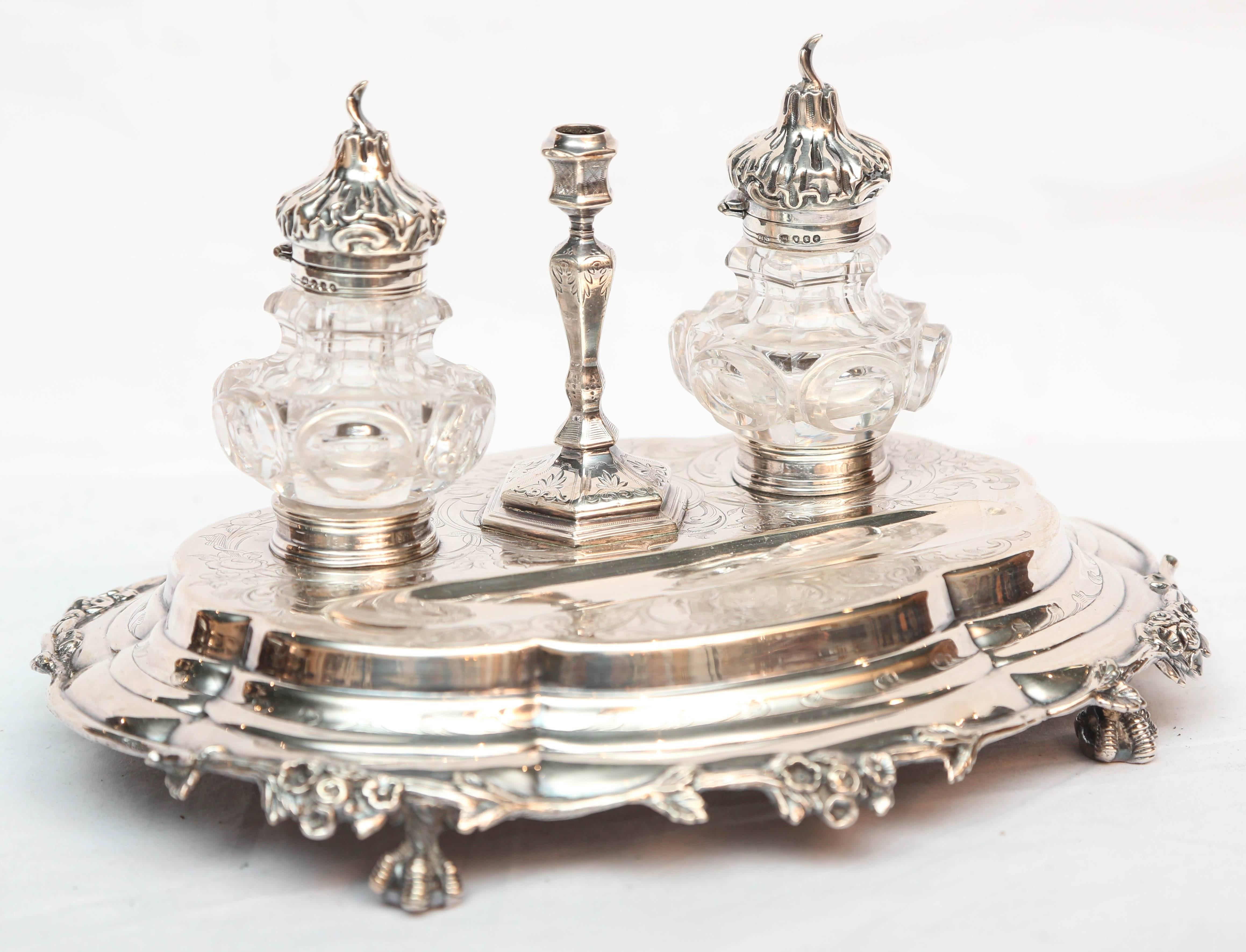Beautiful style and detail with removable inkwells with sterling tops. The stand is raised upon ball and claw feet.