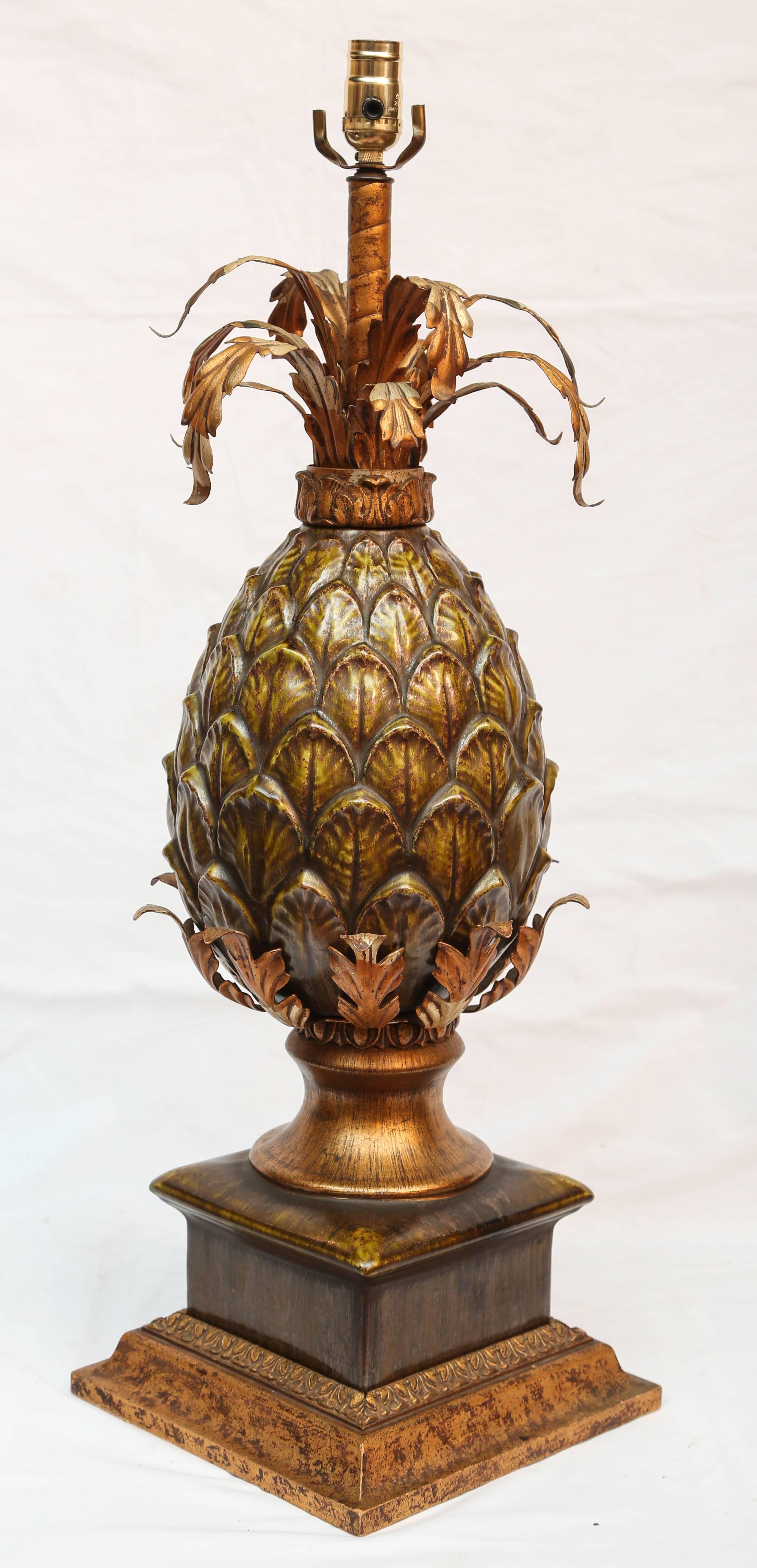 Grand scale with Majolica body and gilt metal details, on a wooden base.