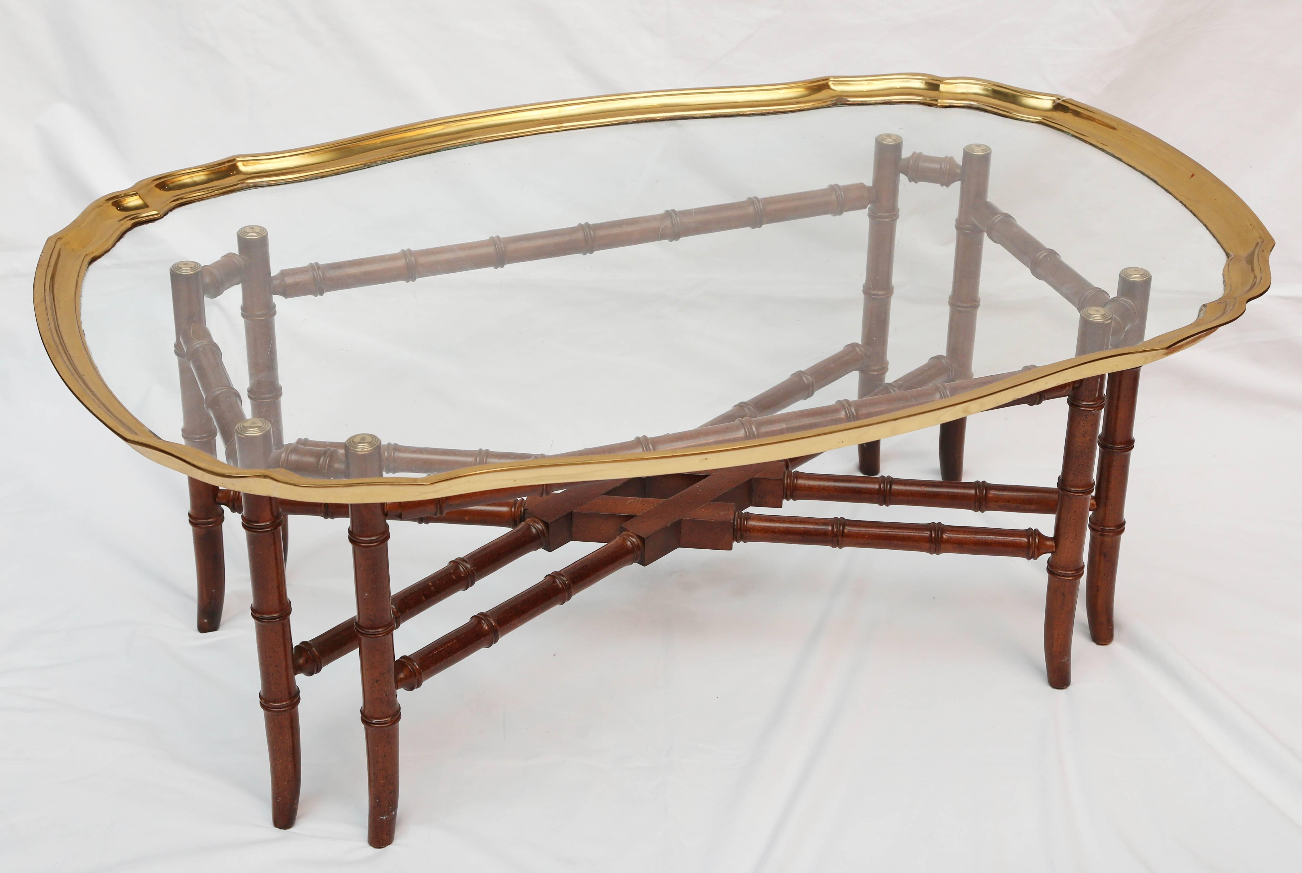 A nicely scalloped brass framed glass top above a fine brass appointed faux bamboo base.