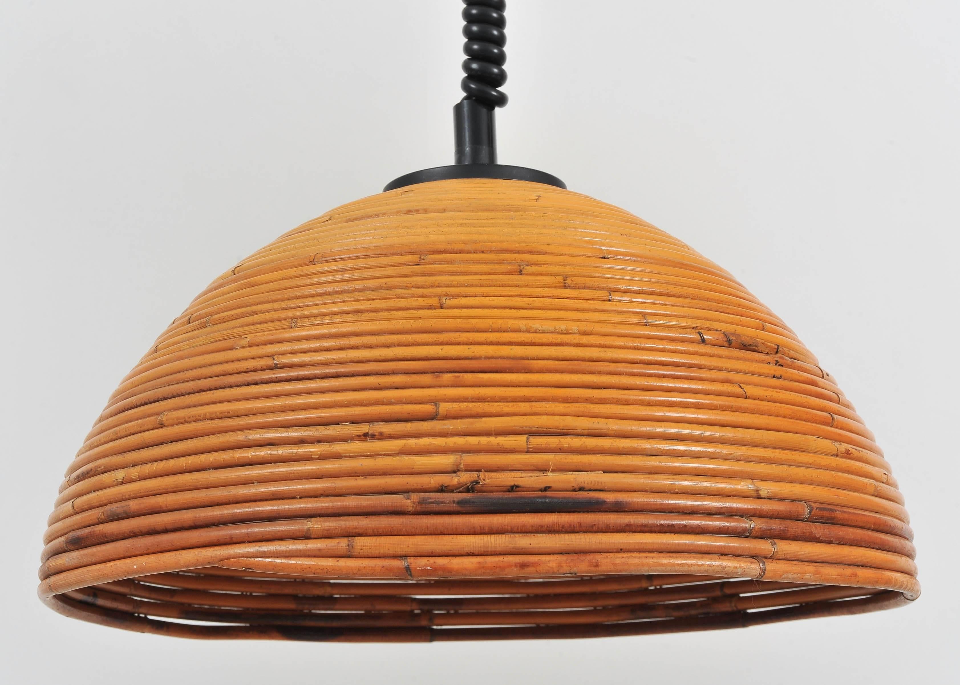 This fantastic Mid-Century light is on a spiral wire so that the height can be adjusted. The rattan shade is a lovely warm color and is a good size. Would work really well over a dining table or in an office.

This light has been fully rewired and