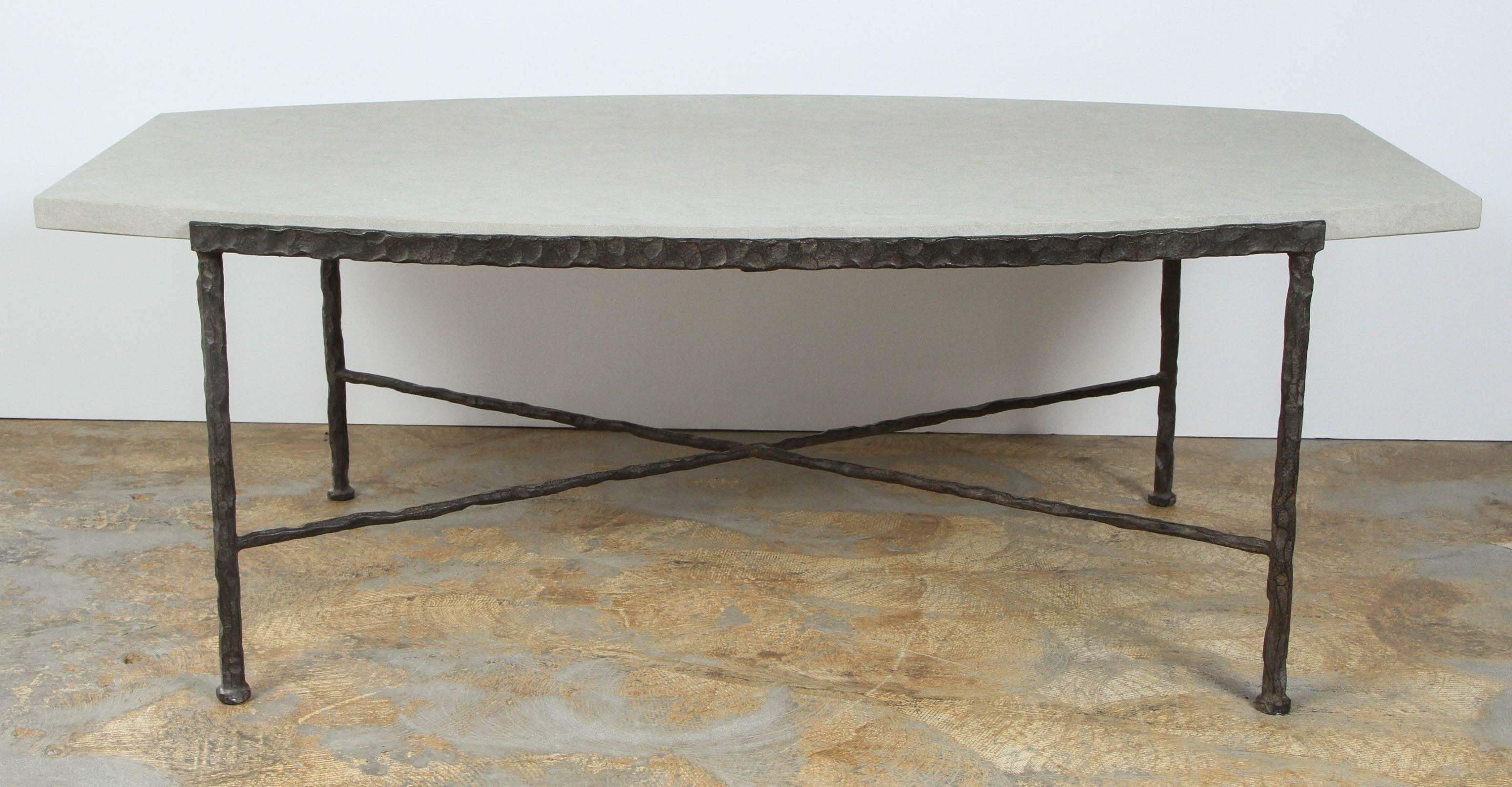 Paul Marra Ellipse cocktail table in textured iron and bateig blue stone. Bowed shape, hand-hammered, Giacometti vibe. By order.

 