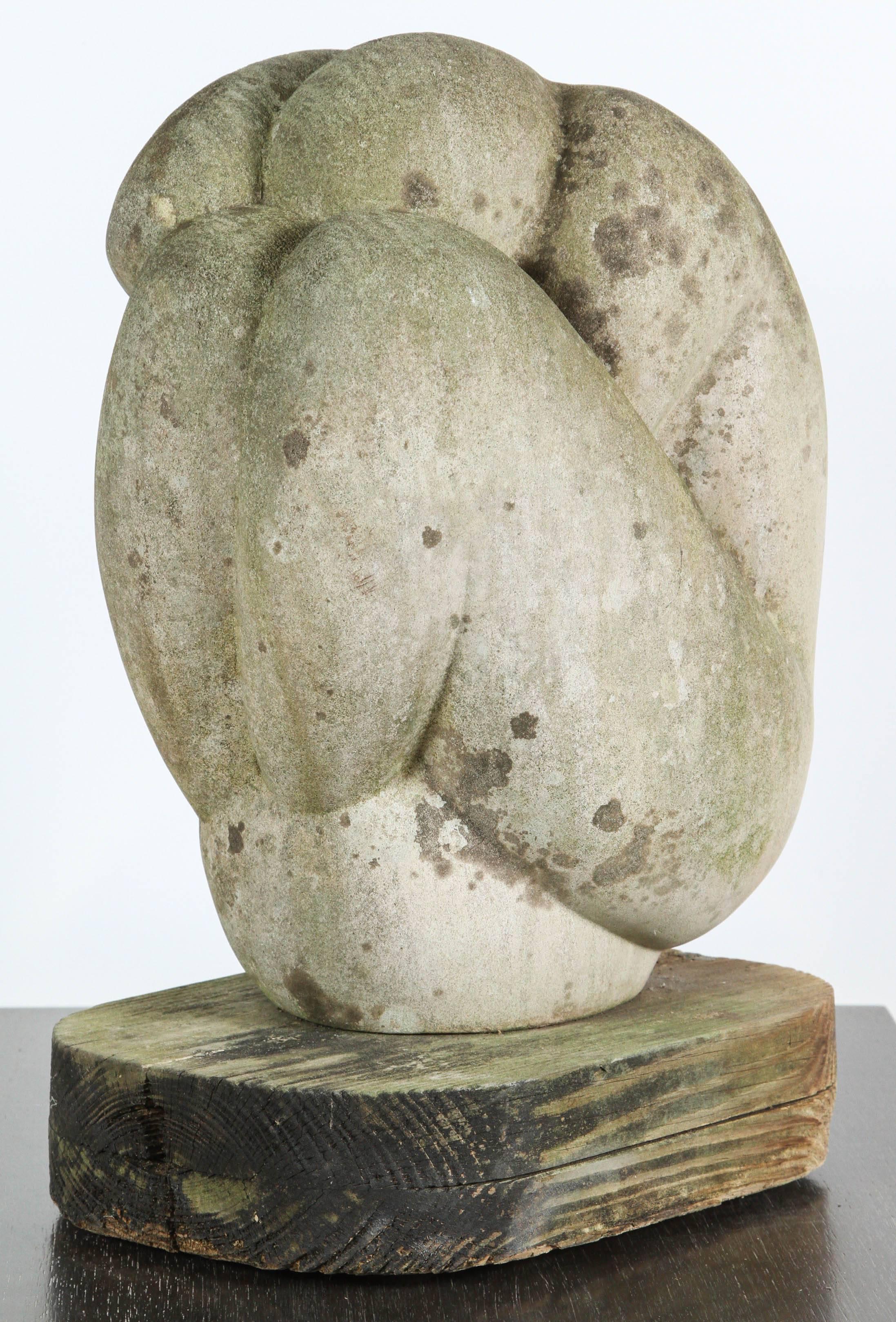 Mid-Century stone sculpture of a figure on vintage wood base.