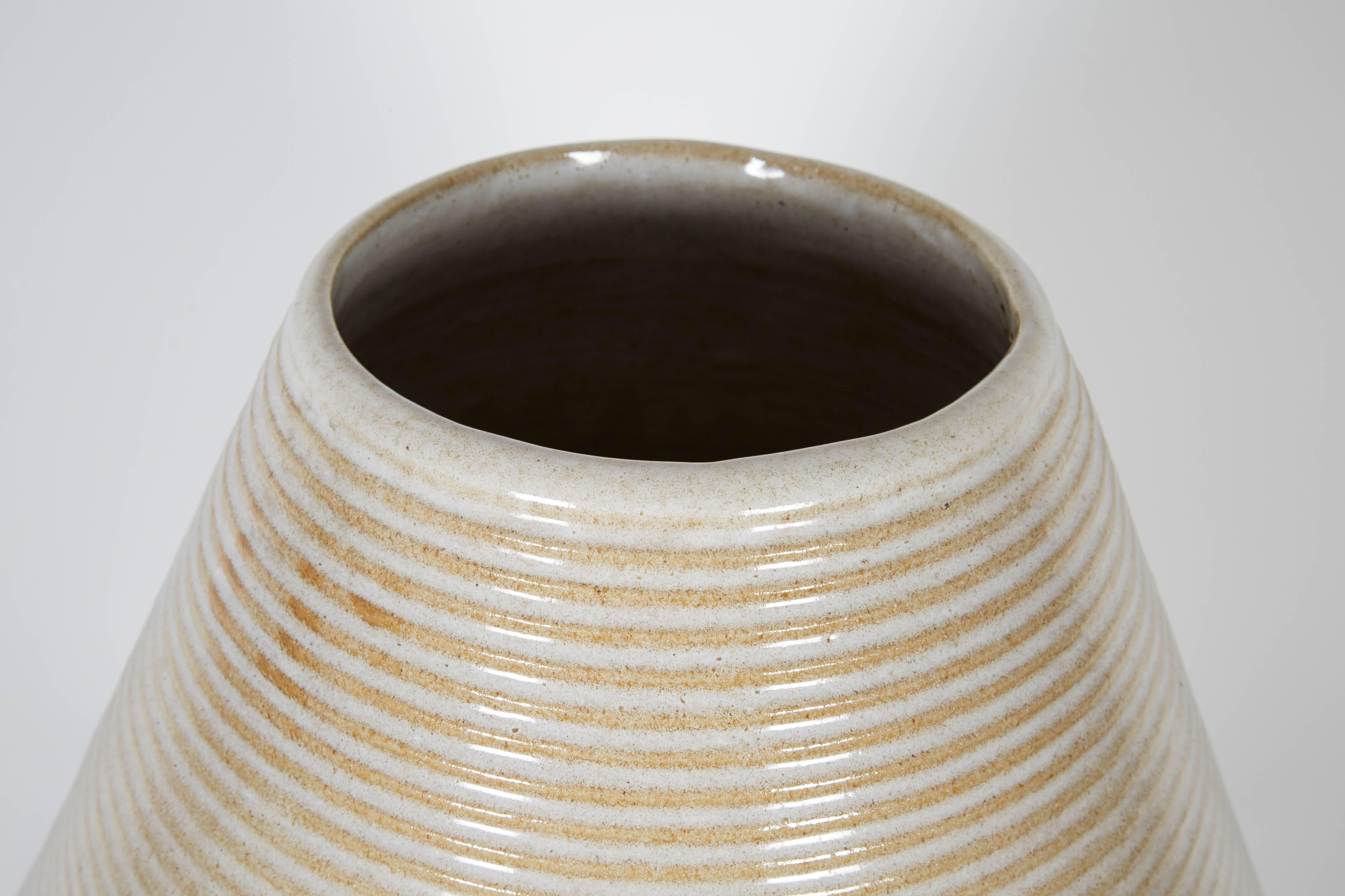 A large-scale pottery vase featuring a ribbed surface detail and clean lines. No chips or cracks. Unmarked.