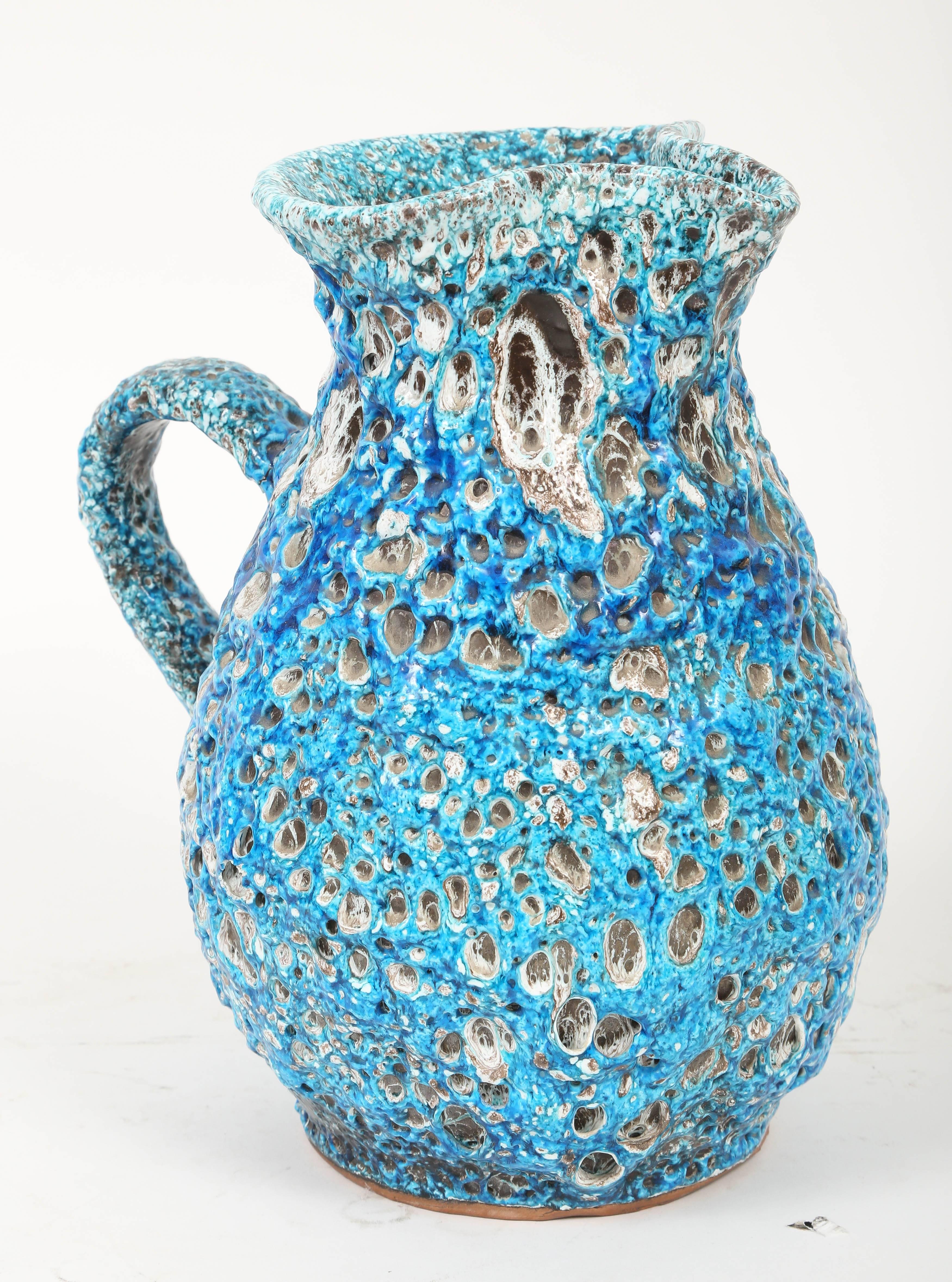 This dazzling glaze was produced in the 1960s in the Vallauris area of the French Alps by Charles Cart. He called it Cyclope because of the large volcanic dimples created during the firing of the pottery which reveal the layers of white and black