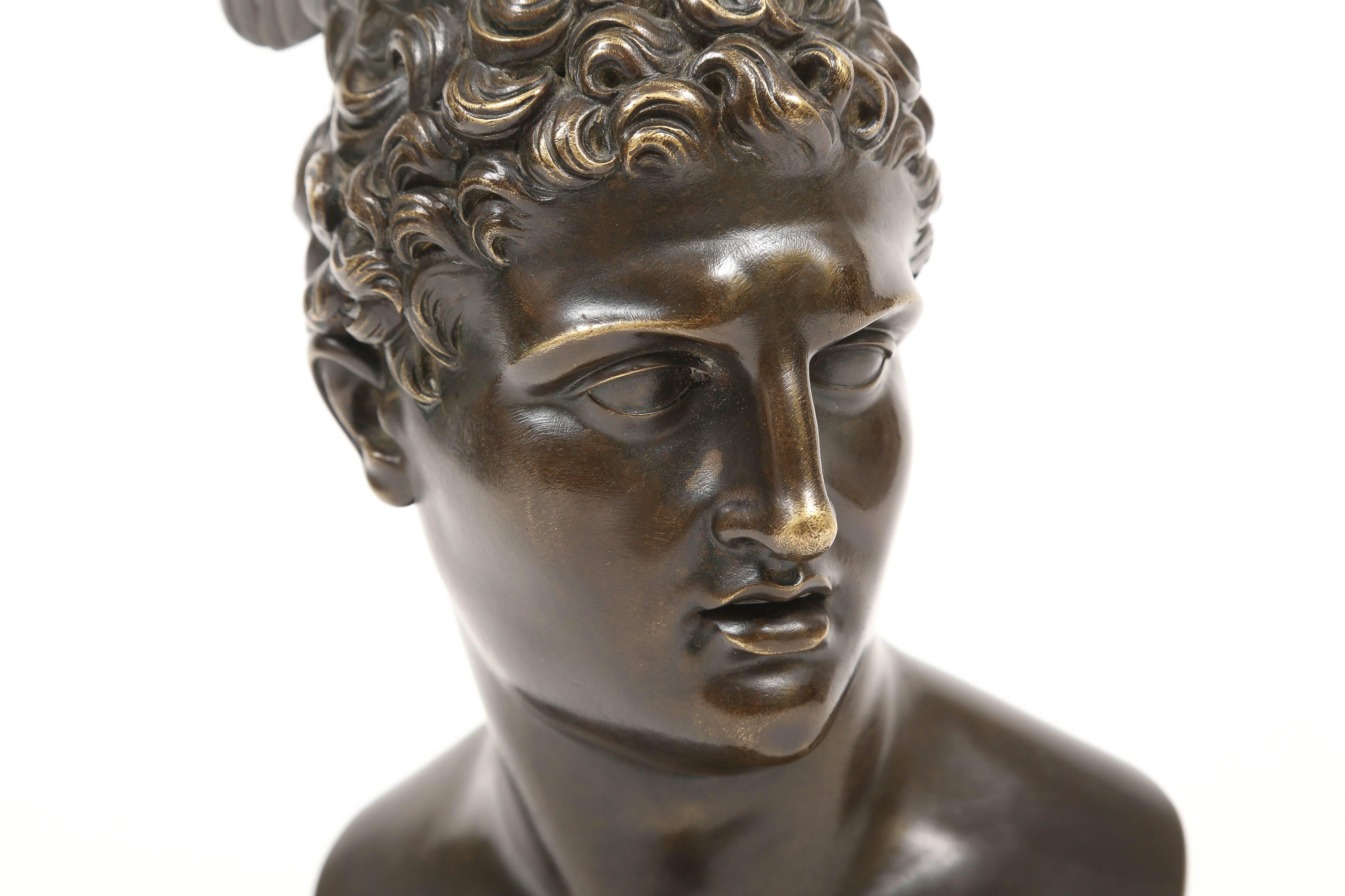 A fine bronze bust of Mercury on a turned bronze socle. A paper label taped on the back states in French "Mercury called Antinous, son of Jupiter messenger of the gods and himself the god of eloquence, commerce and thieves."

