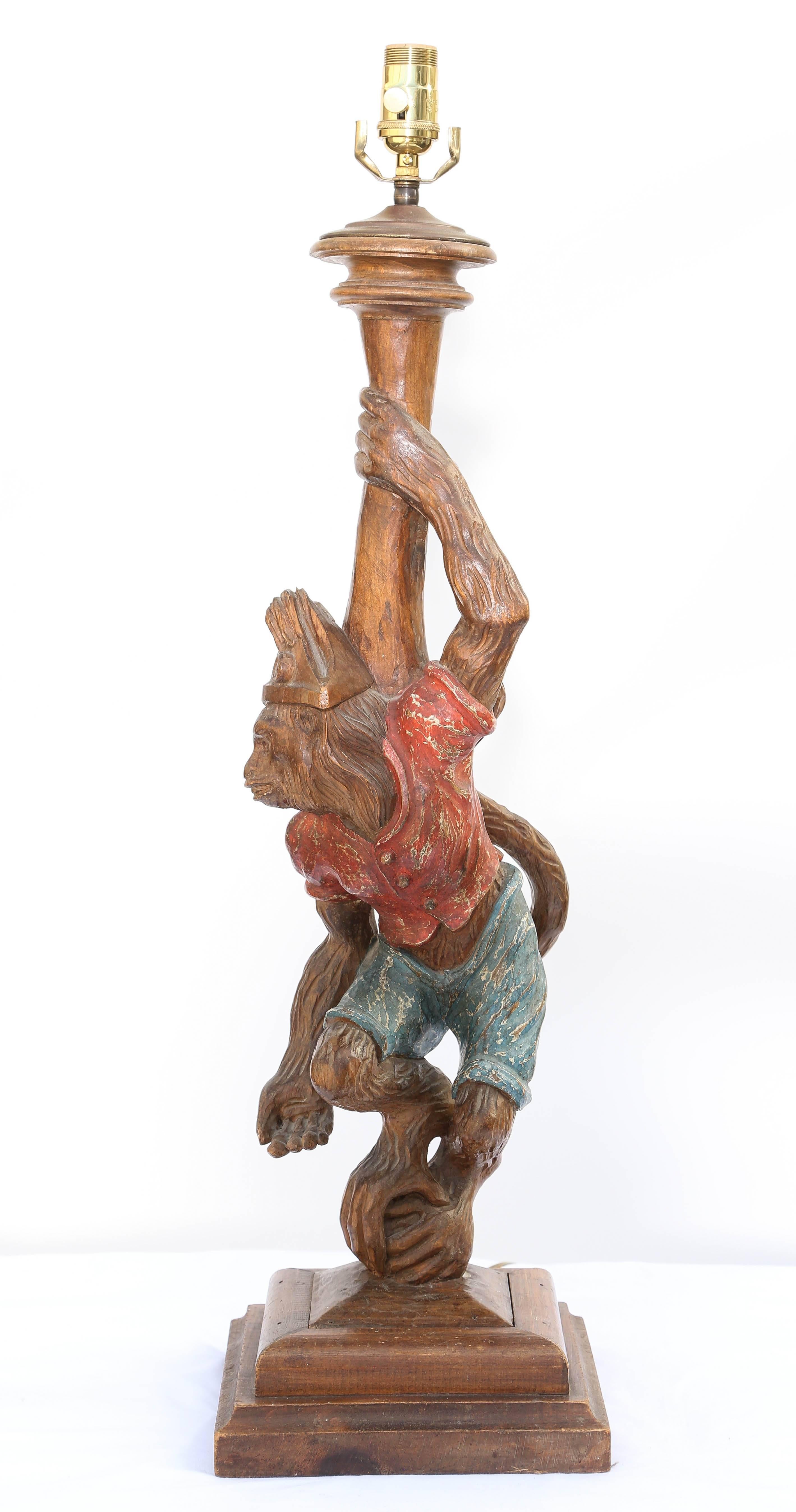 Single lamp, of carved wood, carved as a monkey in pirate dress, on square base.

Stock ID: D5281