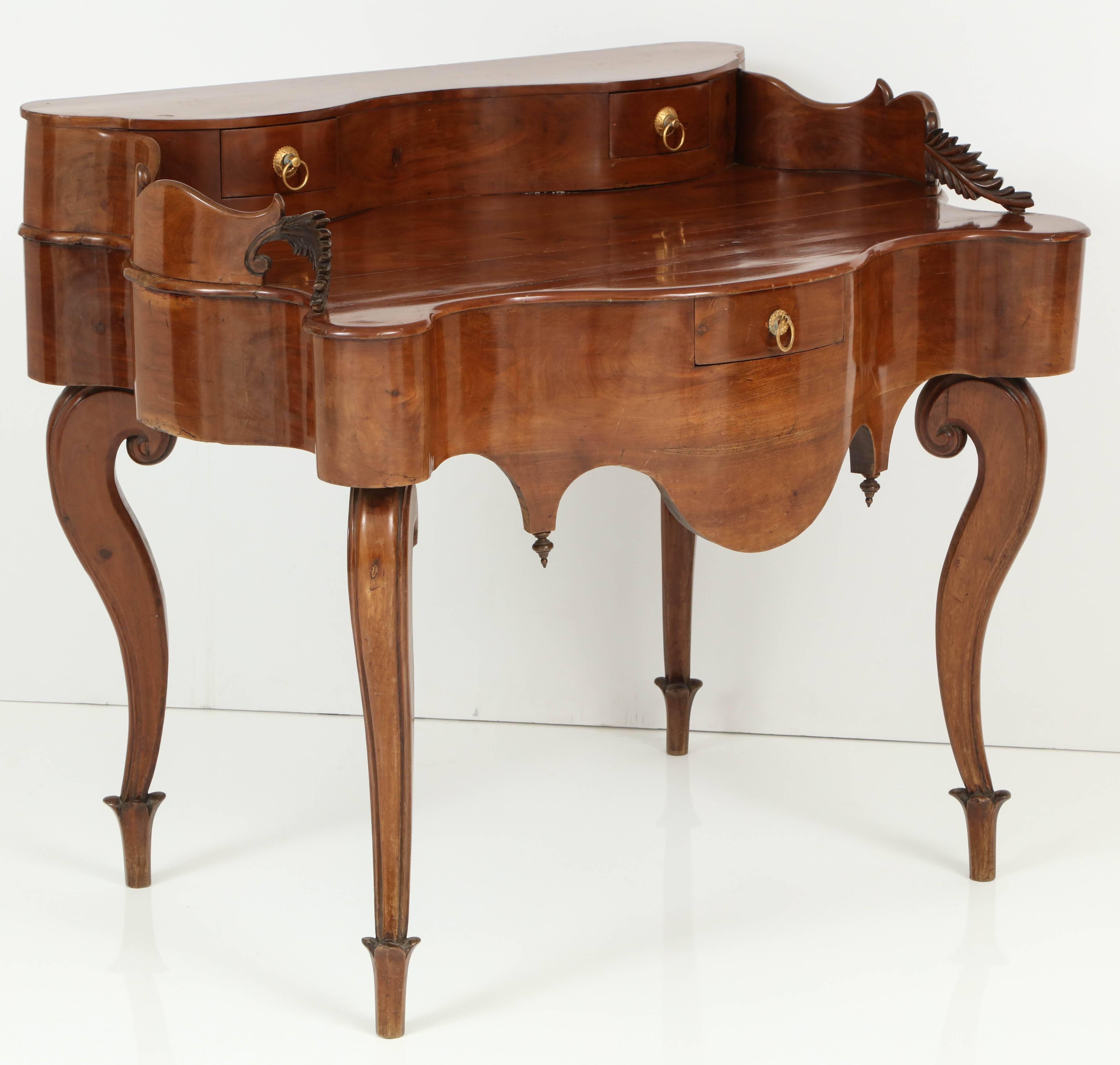 Exquisite late 19th century Spanish desk executed in walnut, wood displays wonderful movement on all sides.