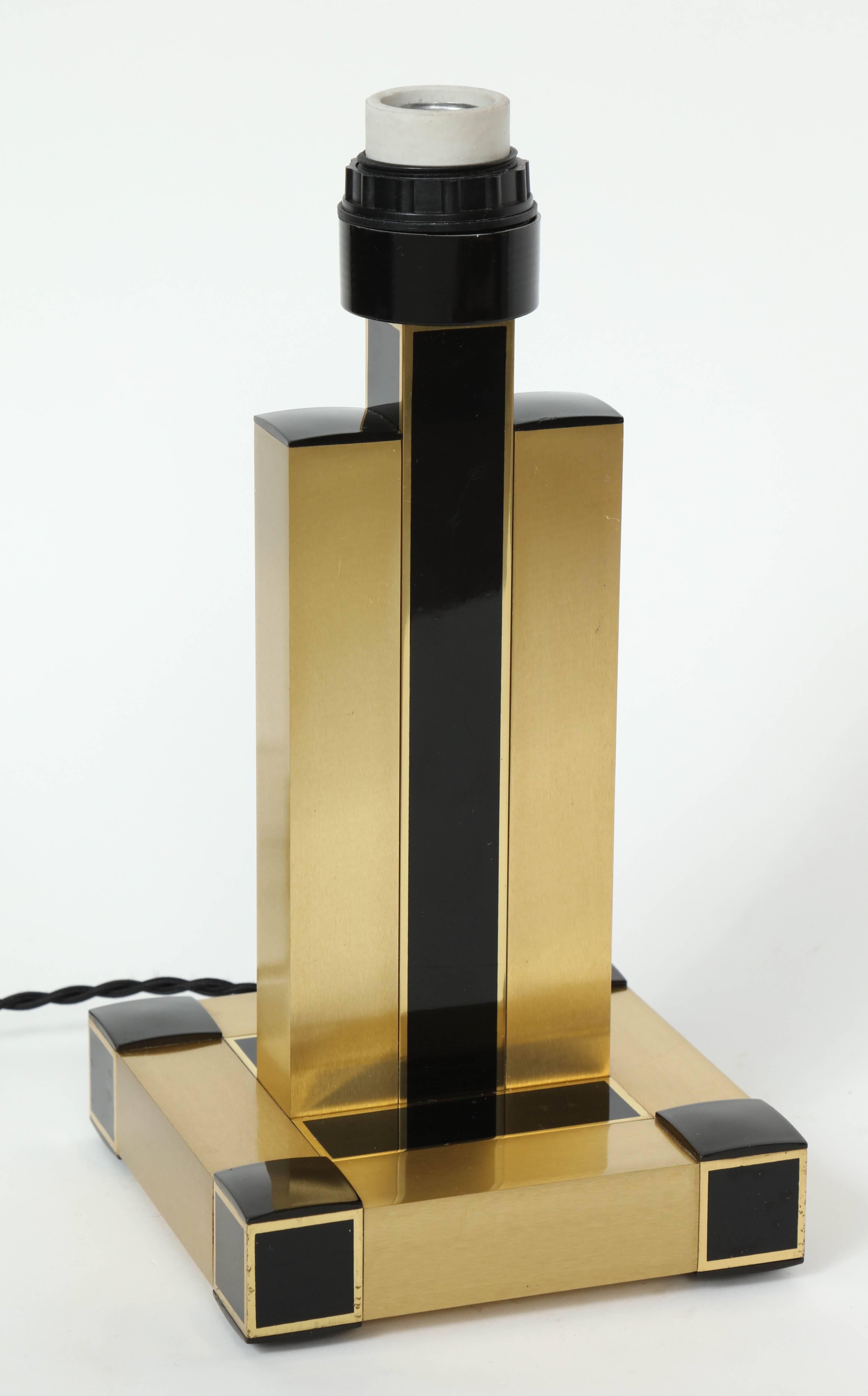 Chic pair of 1970s brushed brass modern table lamps with black resin accents. Rewired for USA with black silk twist cording.