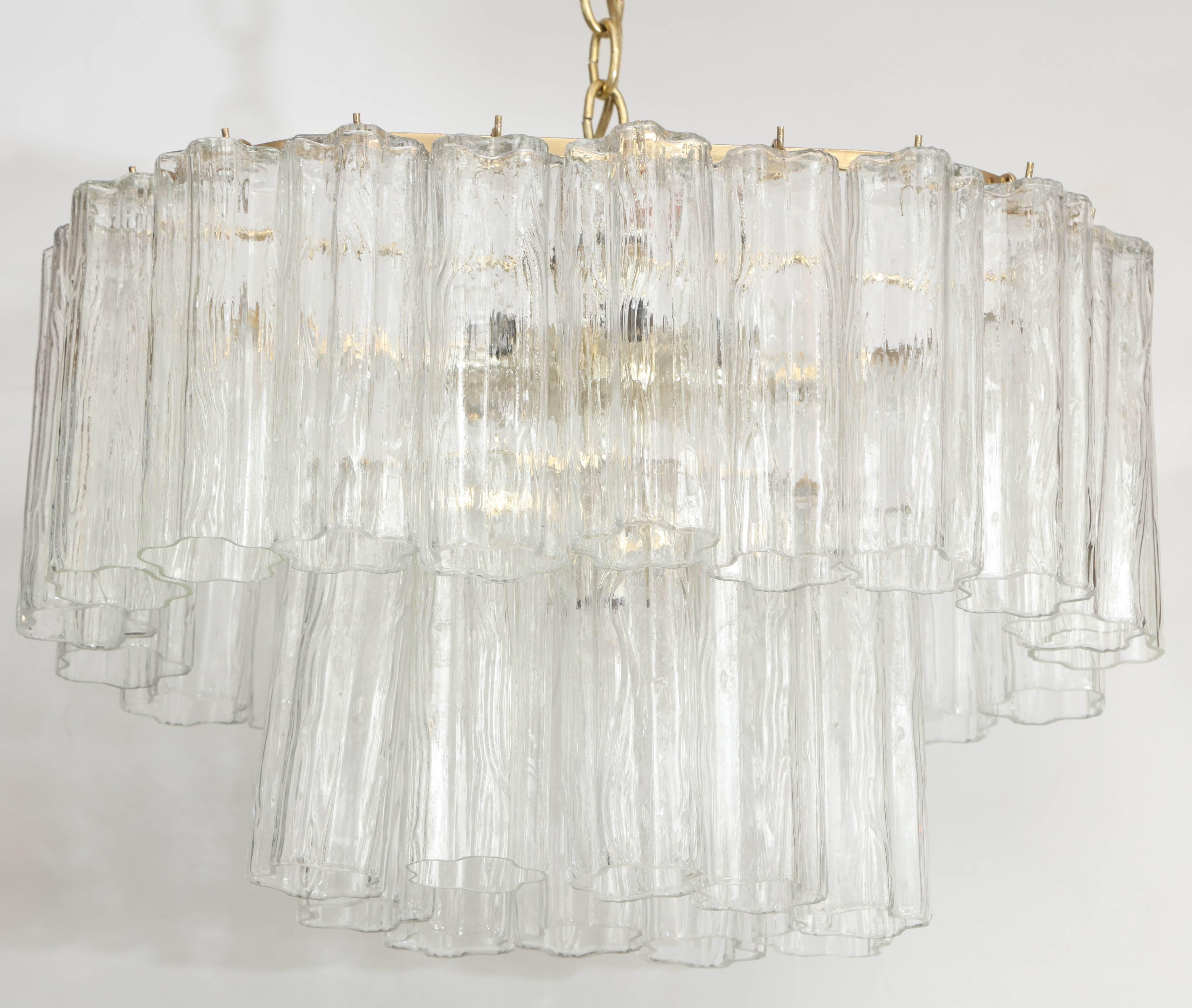 Mid-Century classsic race track chandelier with two rows of murano glass Tronchi tube elements. Chandelier is suspended from a brass chain and canopy, houses eight bulbs, rewired for use in the USA.