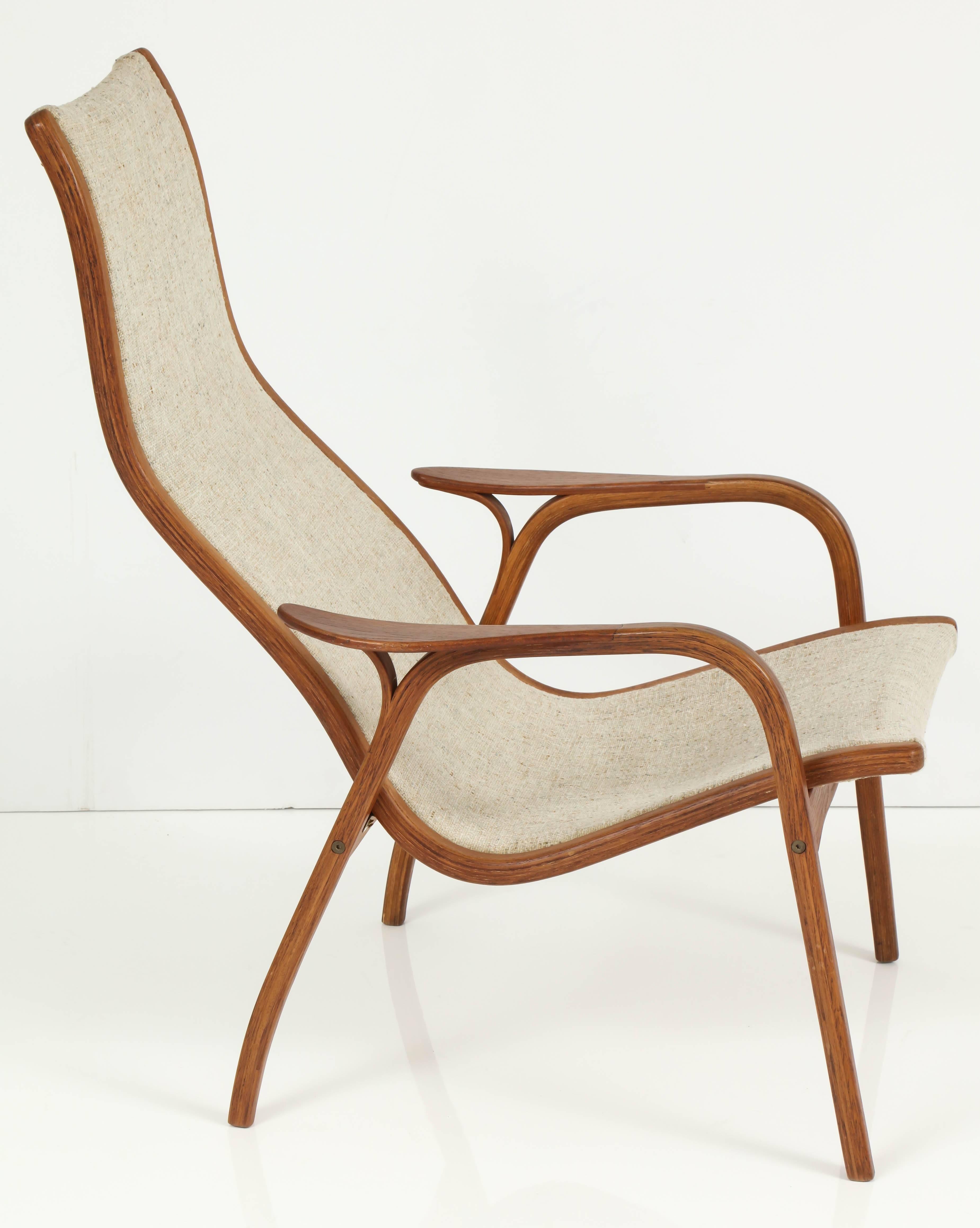 A very comfortable, mid-century modern lounge chair by Yngve Ekström, Sweden, circa 1960. Chair frame is made of teakwood and upholstery fabric is nubby cream wool.