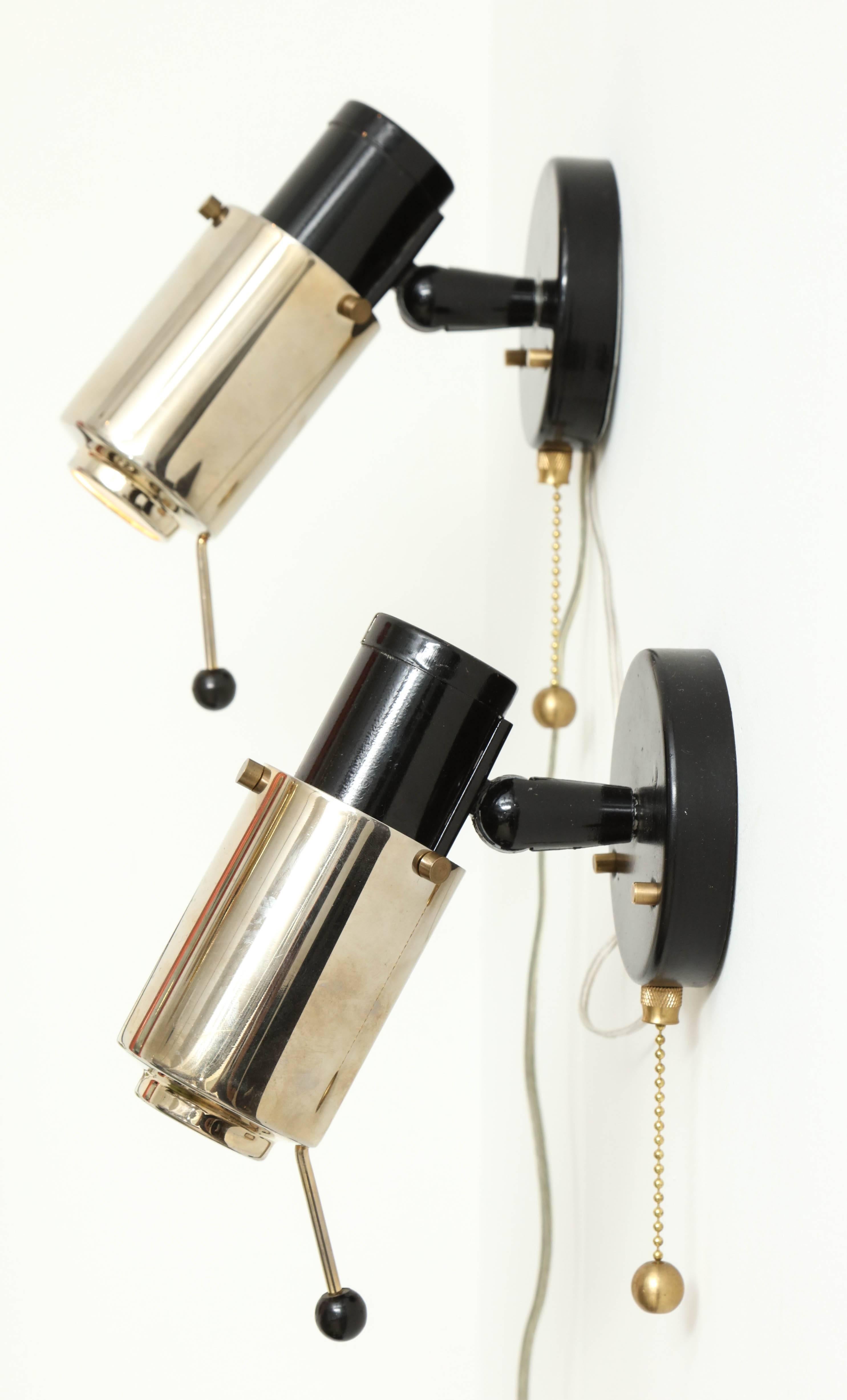 Adjustable sconce or reading lamps in polished nickel, black-painted steel and brass by Jacques Biny for Lita, circa 1960. Newly rewired for US usage and refitted with LED bulbs. An almost identical pair is also available.