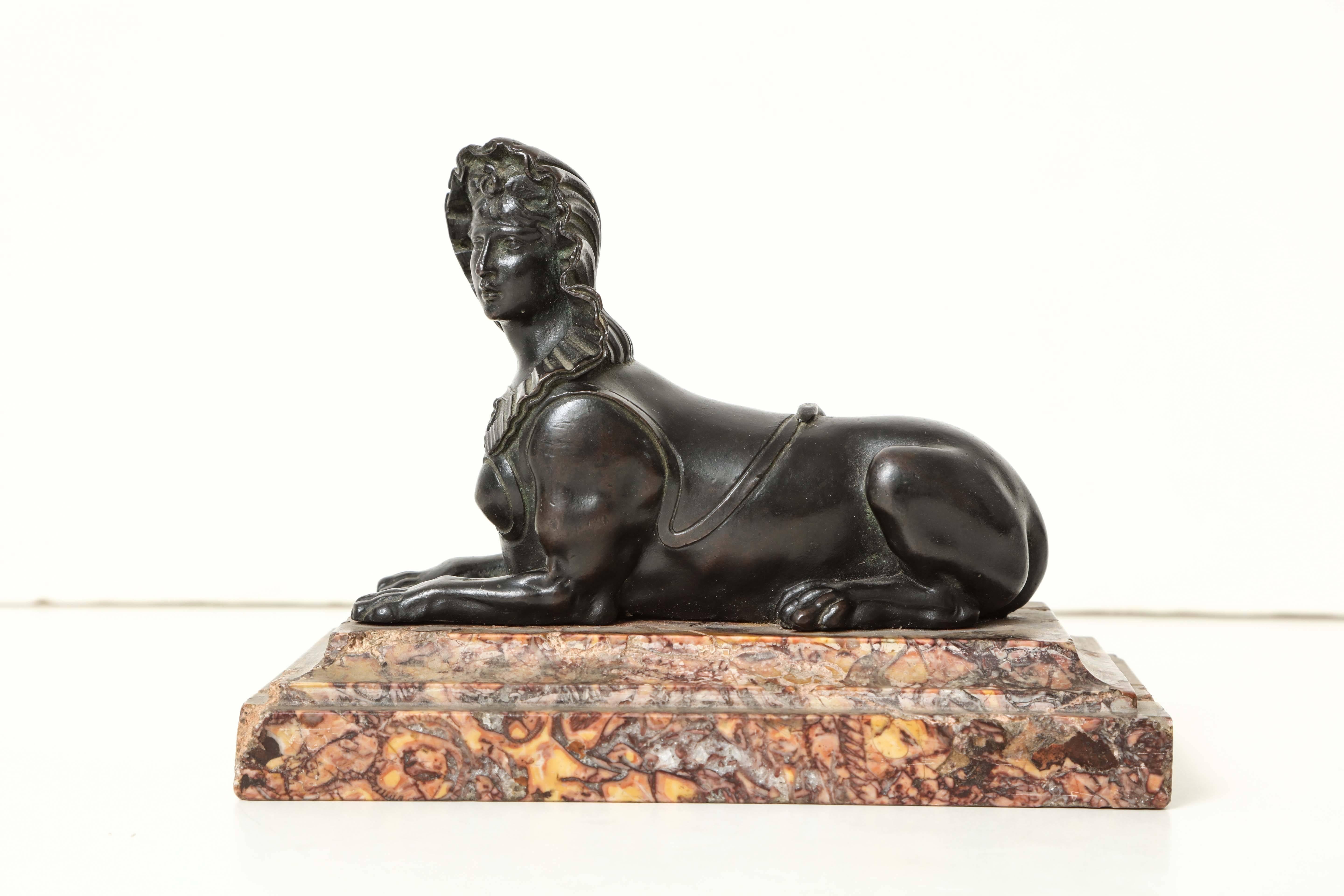 A French Régence bronze sphinx 
on a rectangular marble base
circa 1720.
 