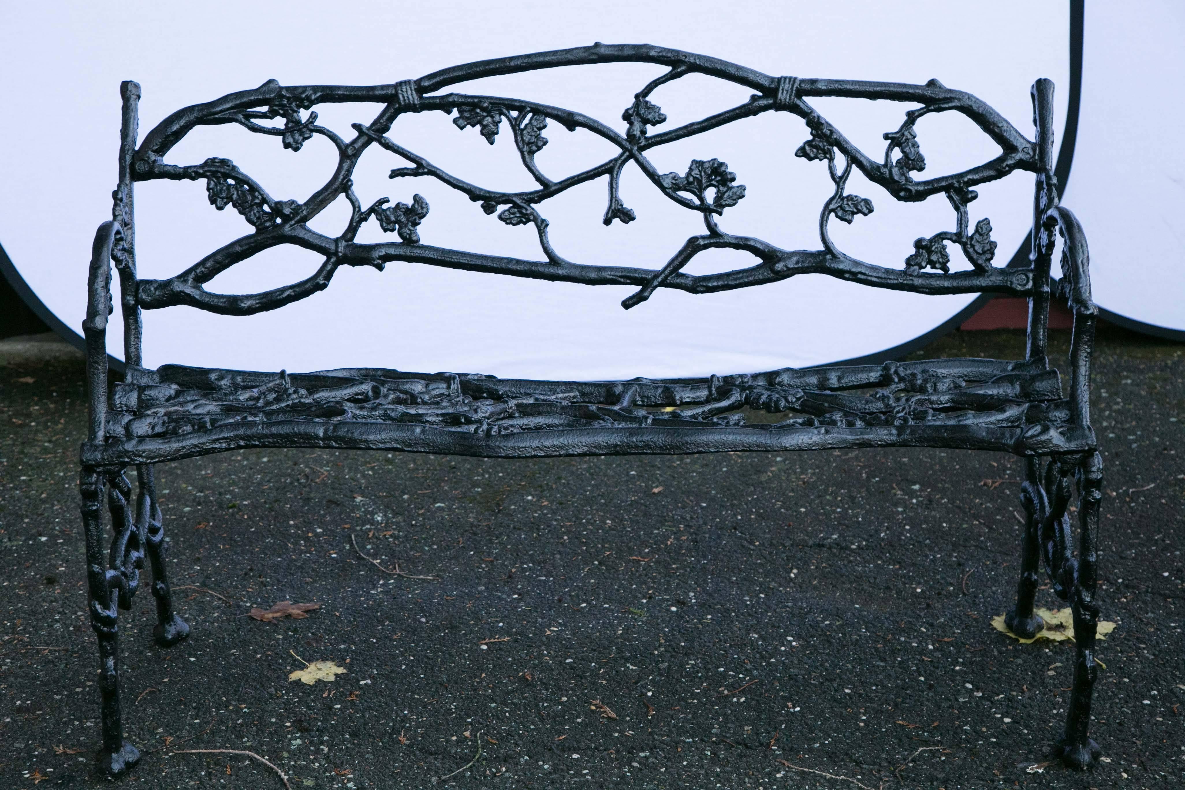Pair of cast iron twig form garden benches having all-over leaf and branch design.
 
