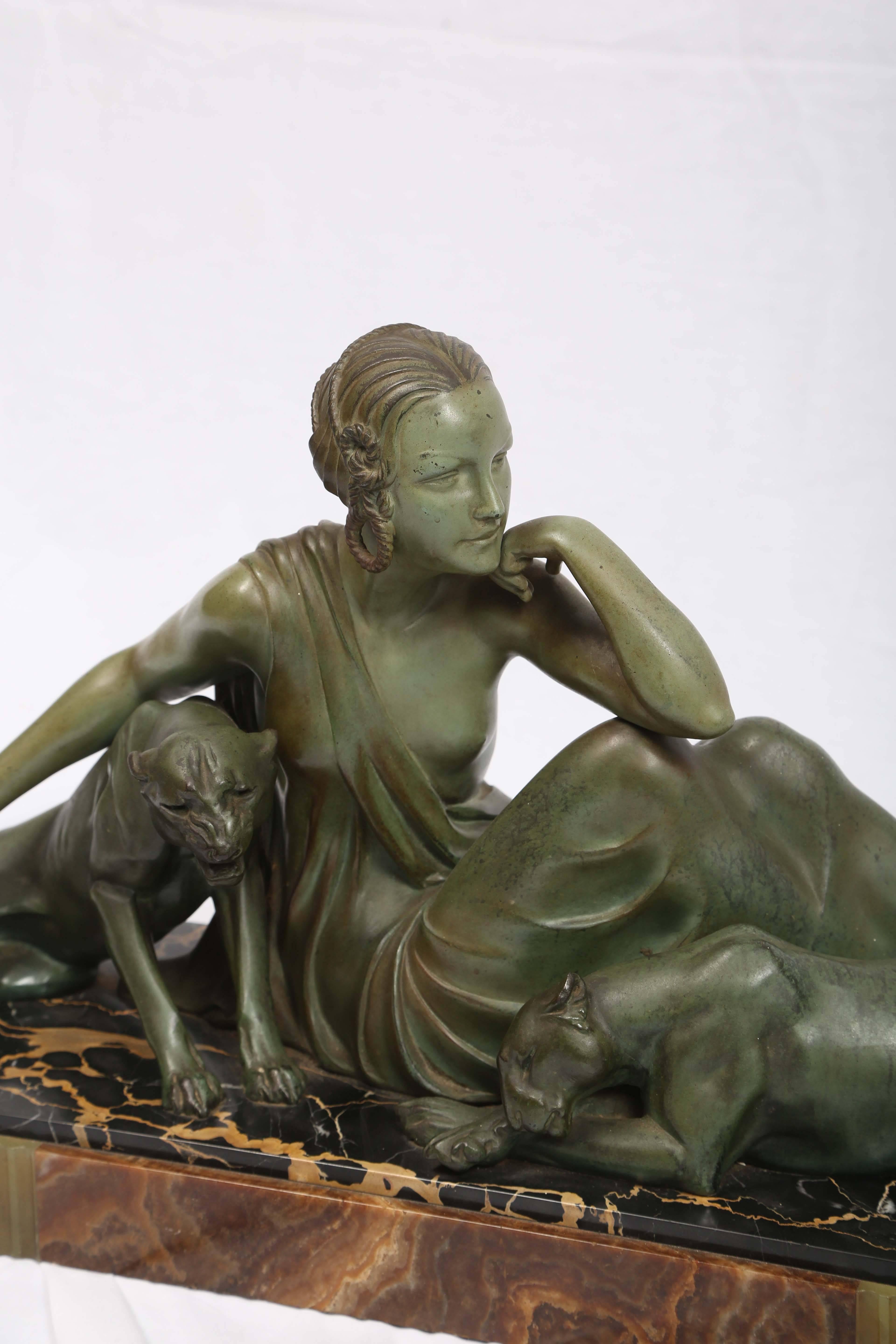 A superbly cast and polychromed female figure posed with two panthers.
Signed Godard on its marble base.