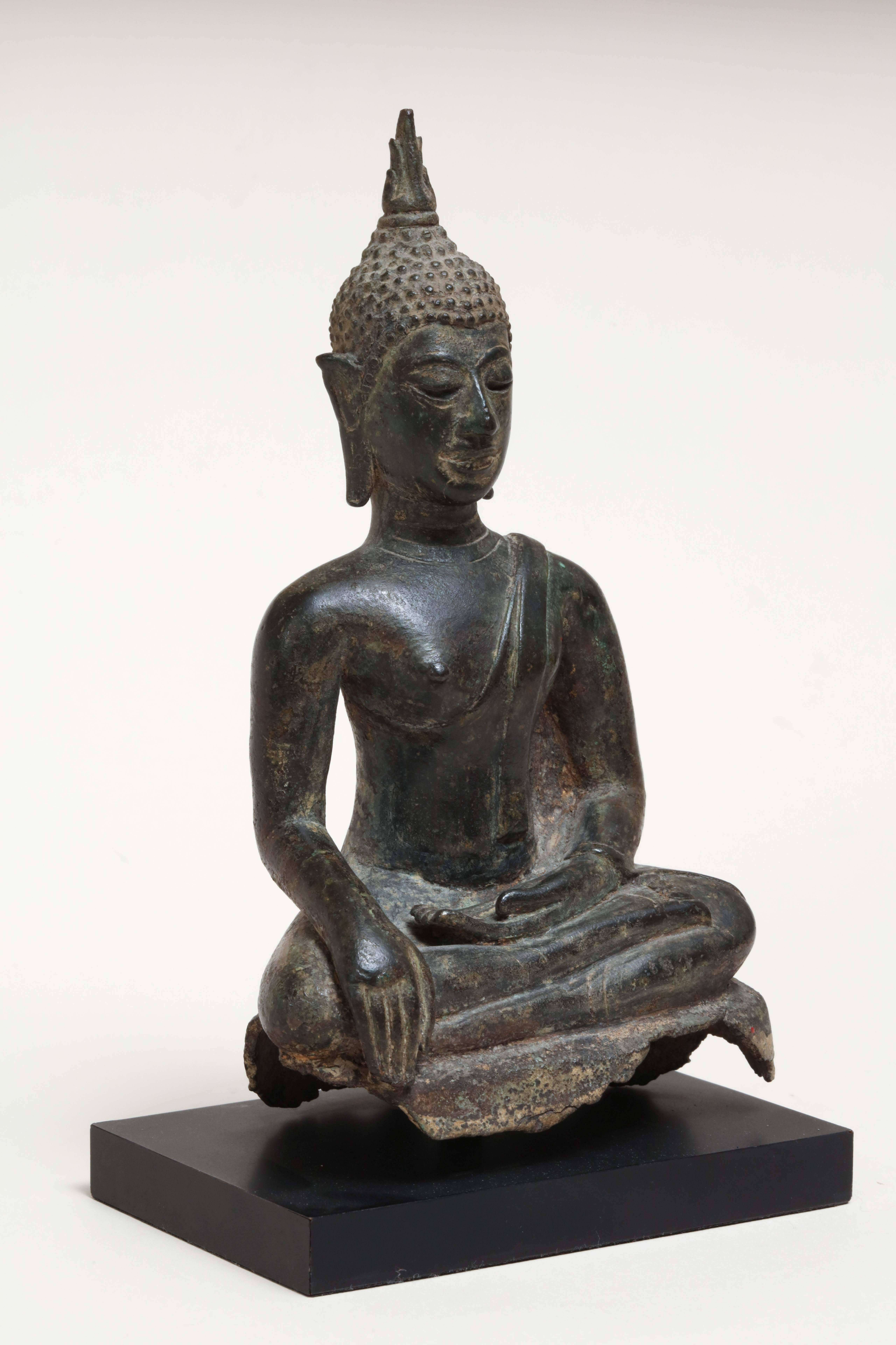 Measures: 8 ¼” high with stand; 4 1/8” wide; 2 ½” deep.
Stand: 4 7/8” wide; 3 3/16” deep; ½” high.

Matte finish on black stand.
Very good condition.

The Buddha is in position Bhumisparsha Mudra. In this position the right hand is resting on