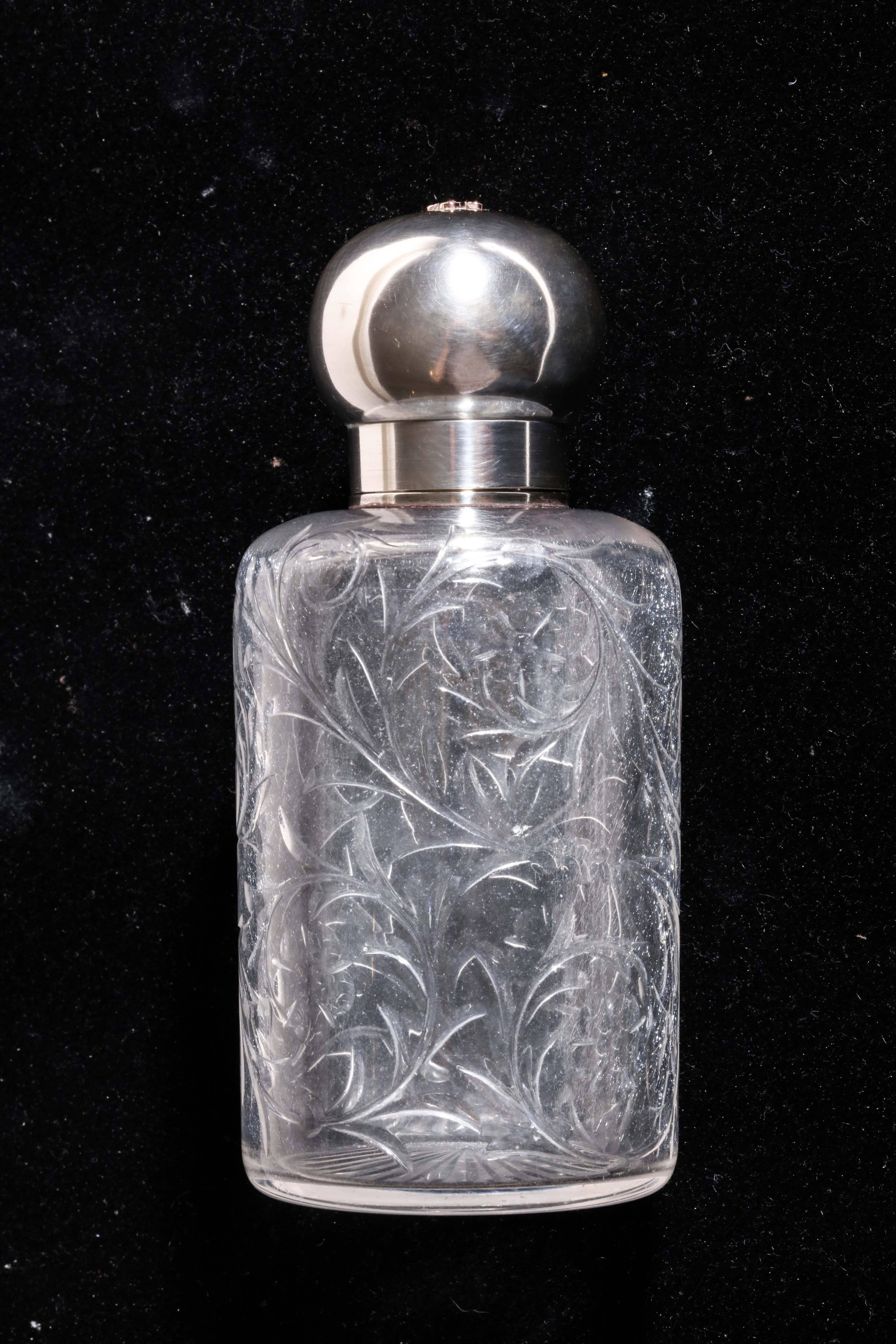 Crystal scent bottle with etched design of flowers and sterling silver top. AJ monogram in gold attached to top.
Impressed with Minerve for 950 silver/ G KELLER / Keller poincon GK head of Mercury.
   