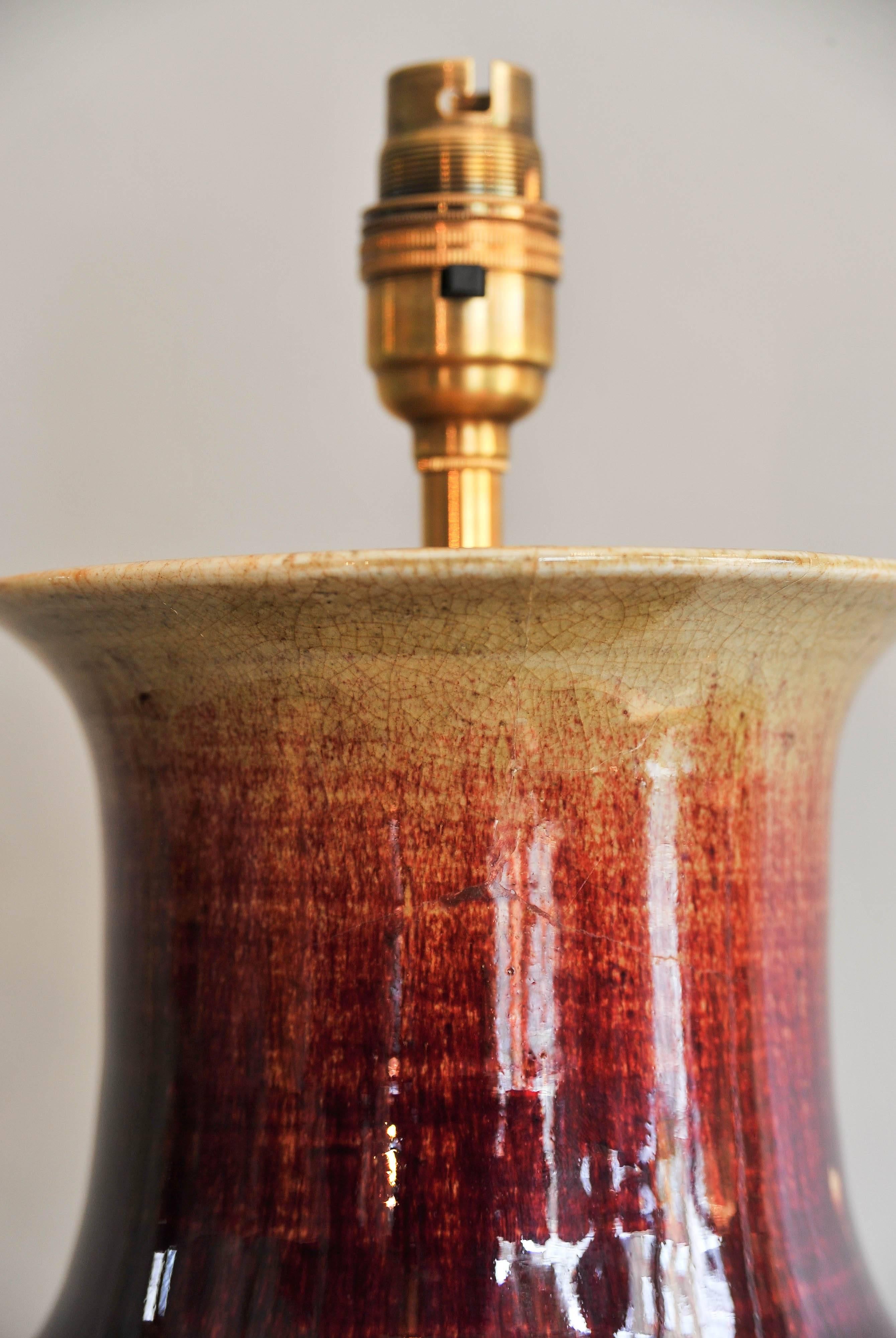 A period (circa 1850) tall Chinese oxblood vase featuring a rich and deep red color with purple shades.
Vase height 40 cm- 15 in.
Lamped with a hand-carved and gilted wooden base.