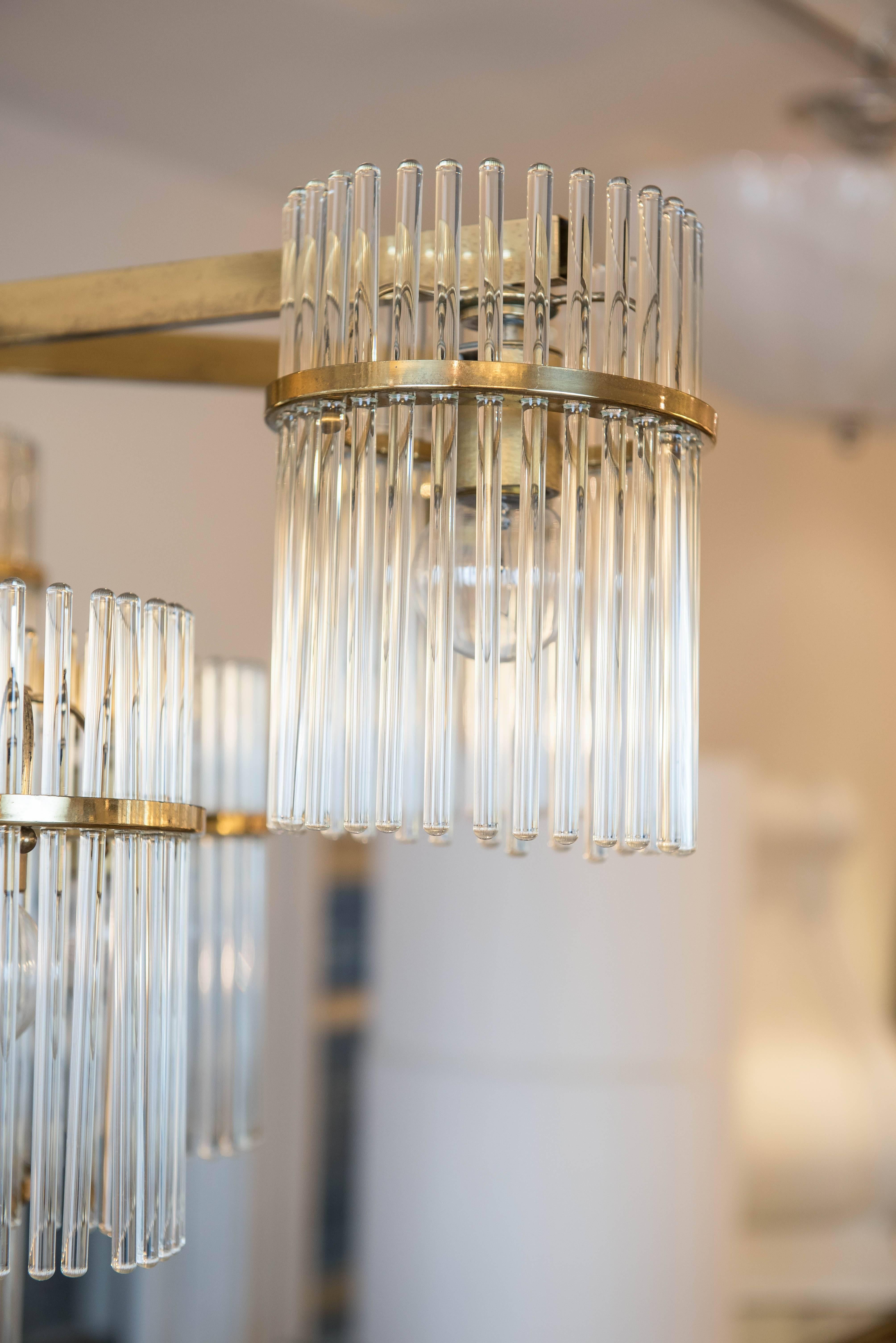This cascading brass plated glass rod pendant has ten lights that face downward illuminating even the darkest of rooms.
It has been rewired and is ready to hang with original canopy with Sciolari
sticker on the inside.
 