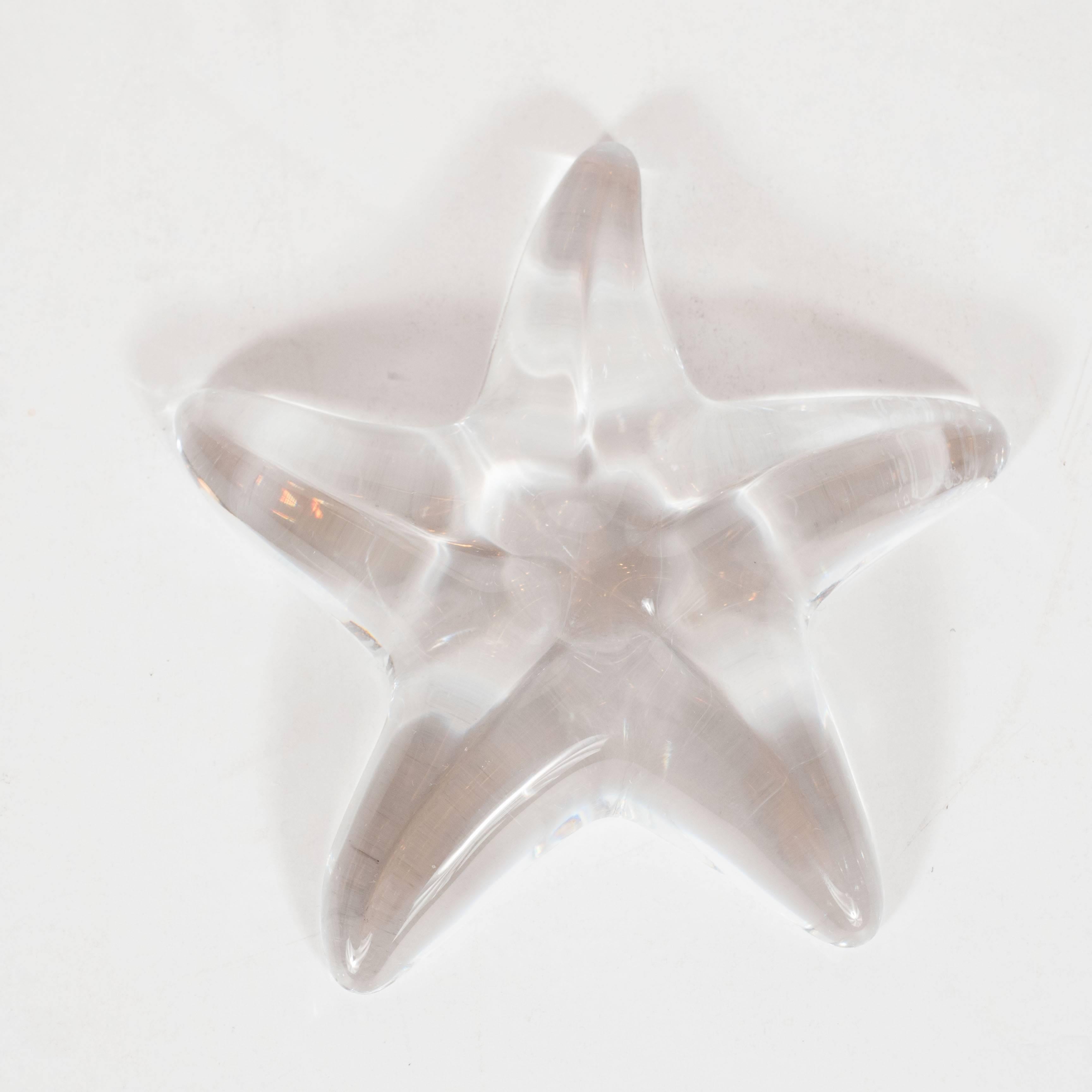 This elegant Mid-Century Modernist Baccarat starfish objet d'art or paperweight features four gracefully curving tendrils with subtle imprinted depressions. It is signed 