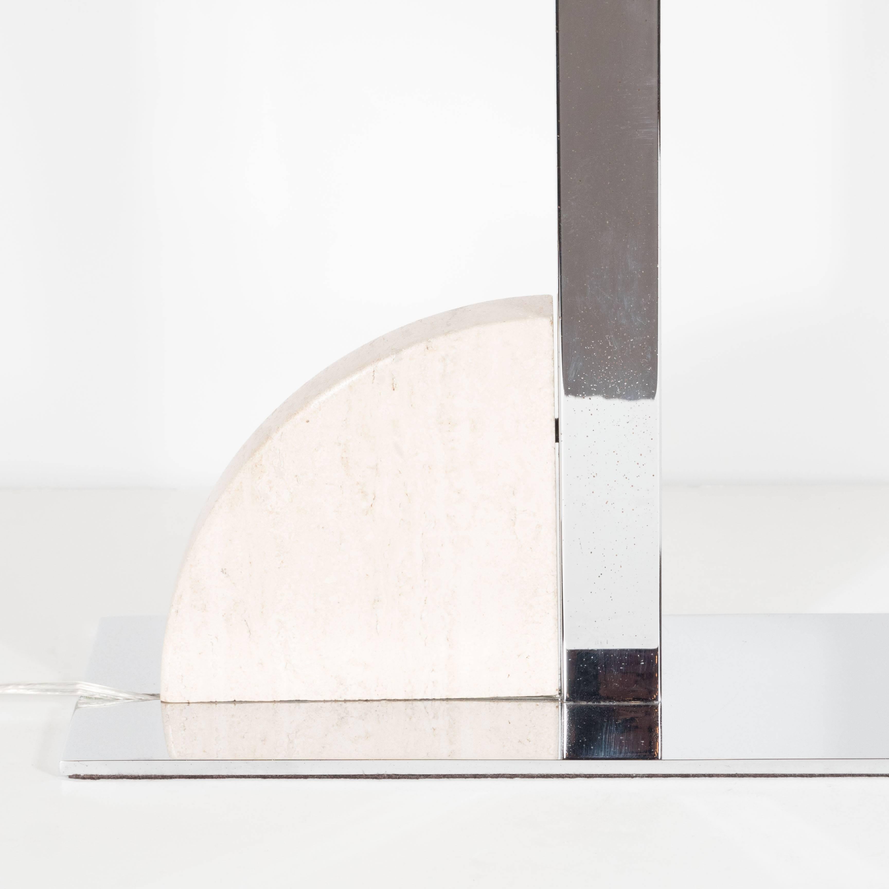 A Mid-Century cantilever chrome and travertine desk or table lamp. A polished flat rectangular base supports an L-shaped rectangular arm. A quarter slice of polished travertine rests on the piece. A two-way switch for differing intensities of light