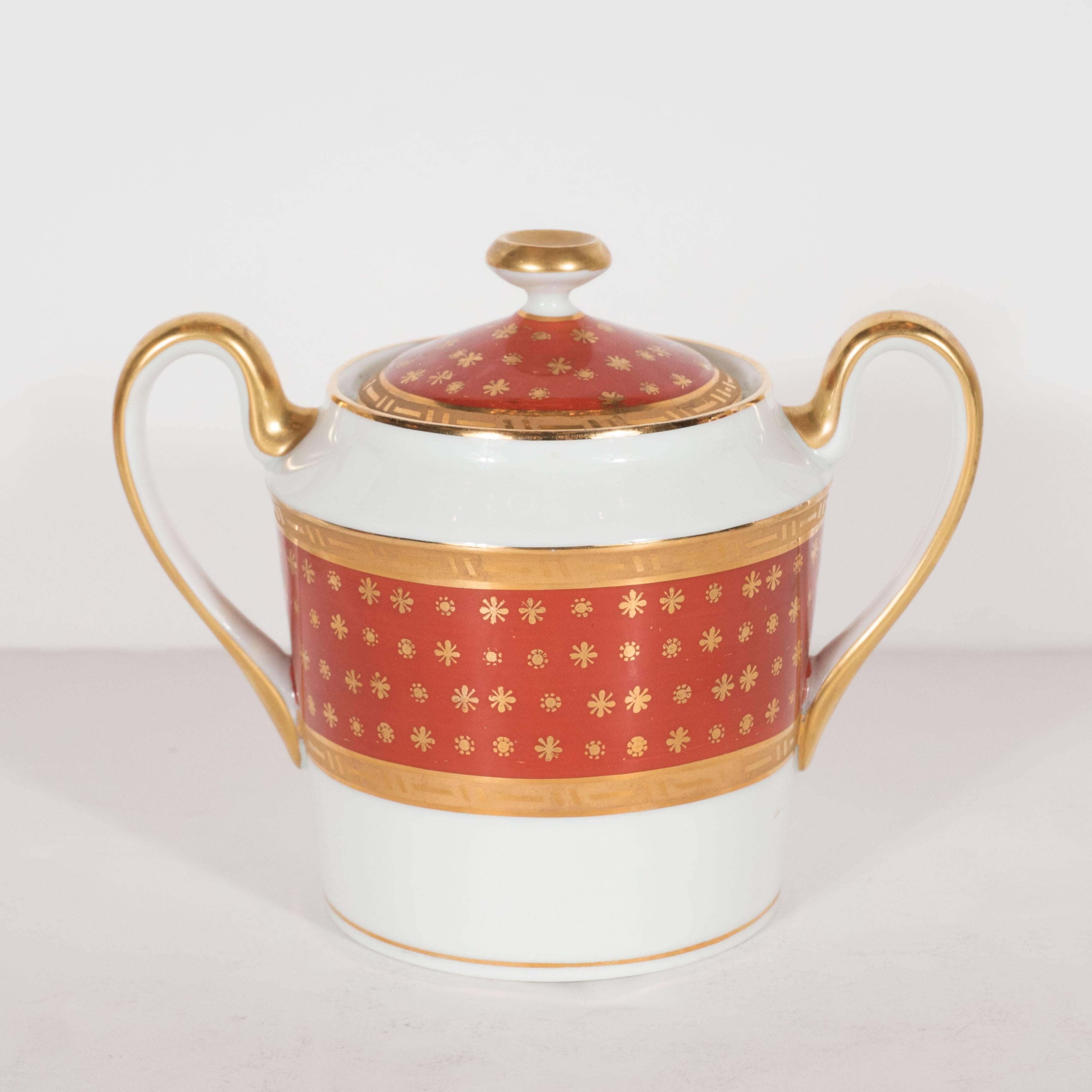 This stunning coffee service by Giraud Limoges features 12 demitasse cups with accompanying saucers, coffee pot, sugar bowl, and creamer. They are feature rich carnelian band inscribed with stylized Fleur-de-Lis, abstracted floral patterns and