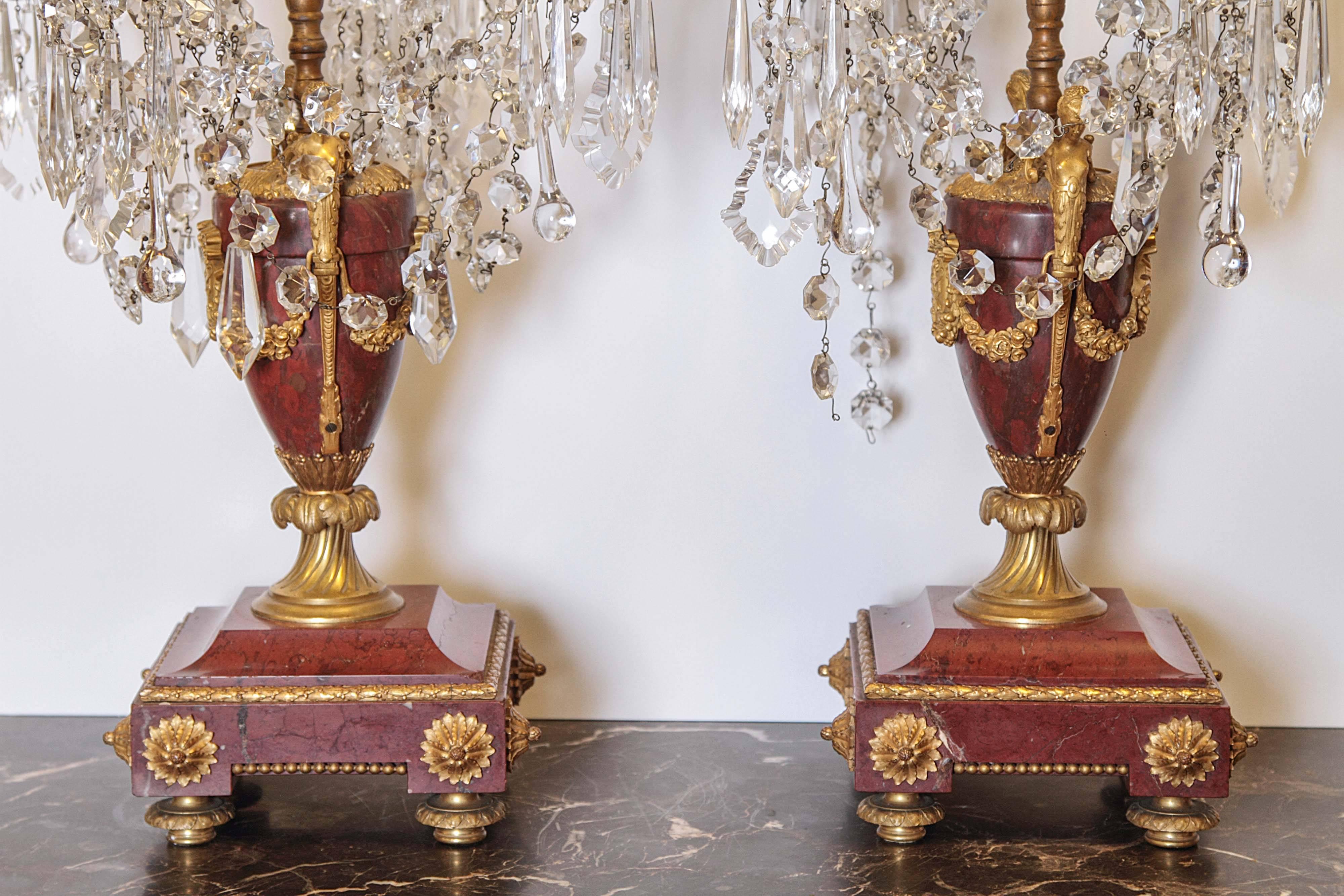 Pair of 19th century marble and bronze four branch girandoles. Red marble base and urn with cut crystals.