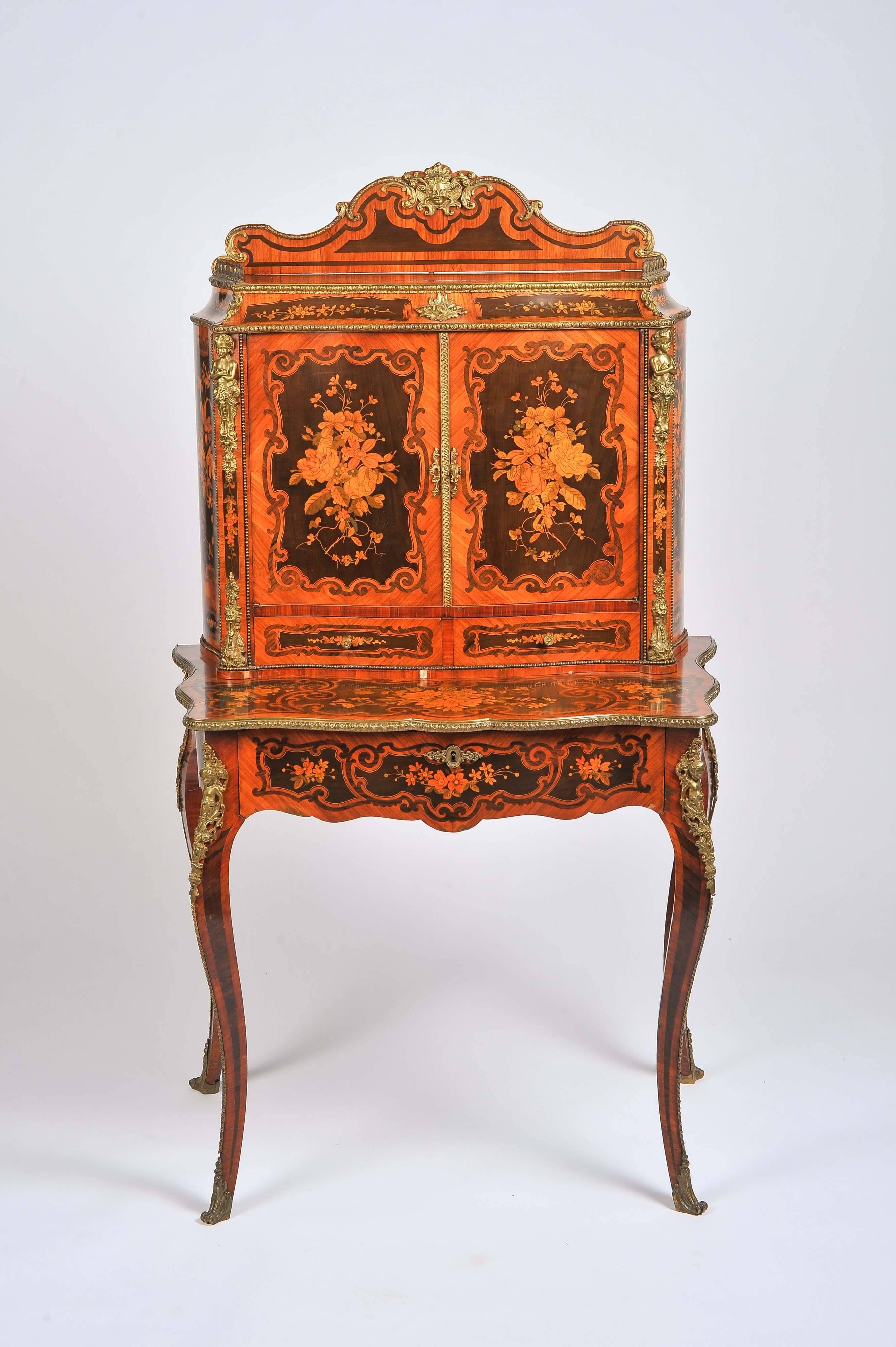 A fine quality Victorian marquetry inlaid walnut bonheur-du-jour, having wonderful floral pattern panels to the doors, sides and base, ormolu mounts. The doors open to reveal a shelf within, the frieze drawer opens to reveal a hinged leather writing