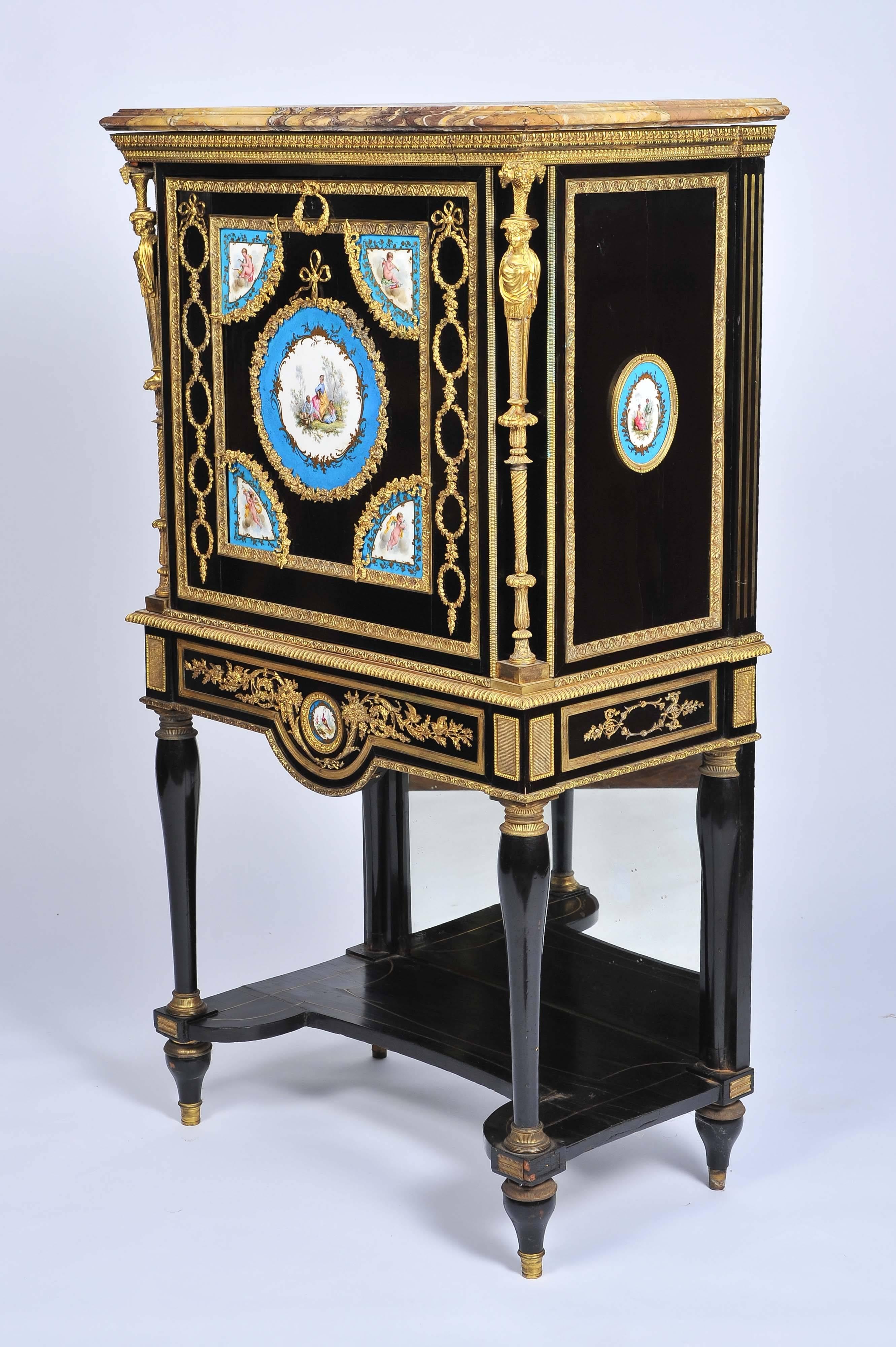 A fine quality 19th century French ebonized secretaire abattant, having its original brocatelle marble-top, classical gilded ormolu mounts of swag, ribbon and caryatid design. The fall front and sides having beautiful hand-painted 'Sevres' porcelain