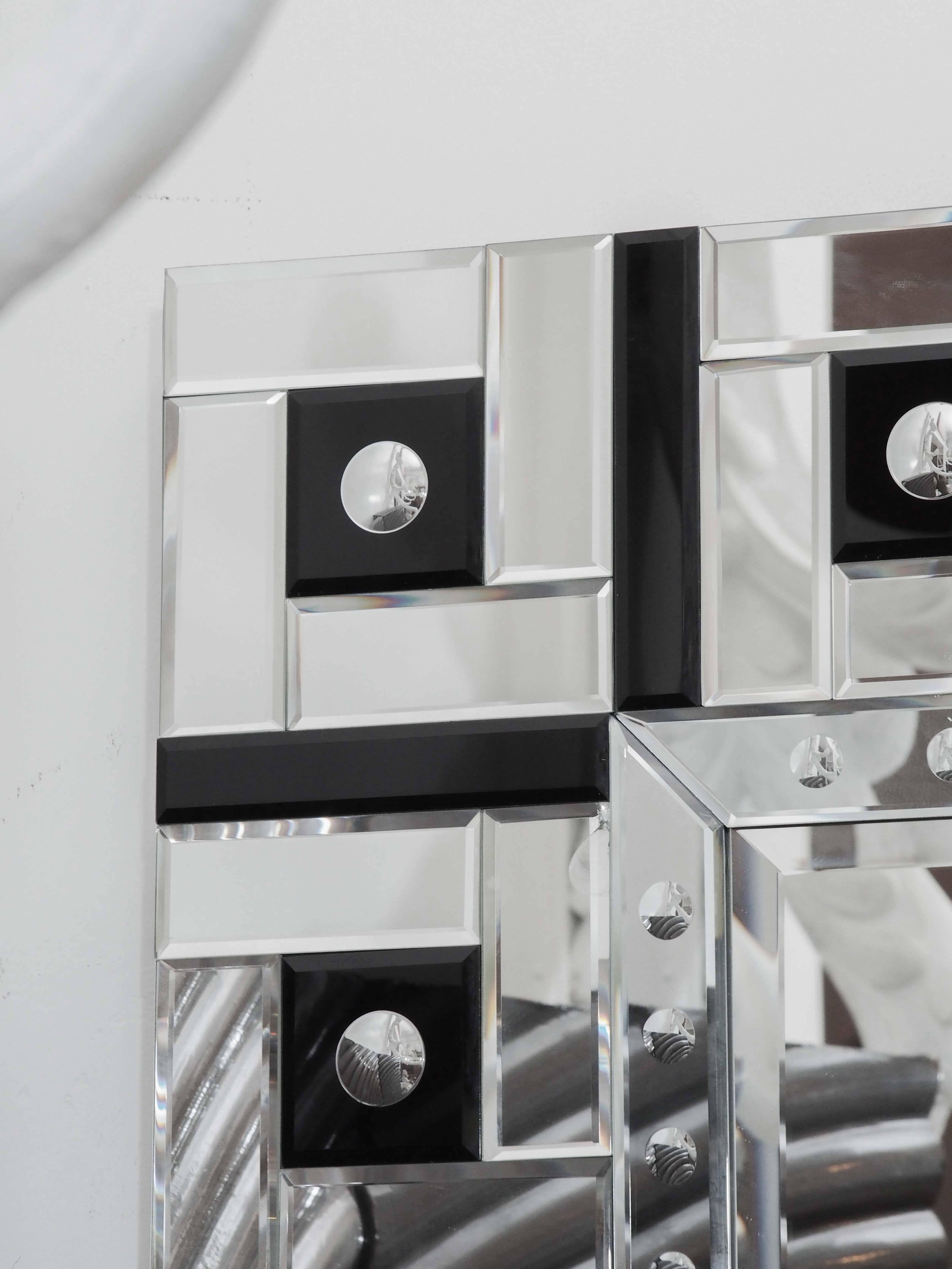Beautiful pair of Art Deco mirrors from France with square detailing and beveled edges.
