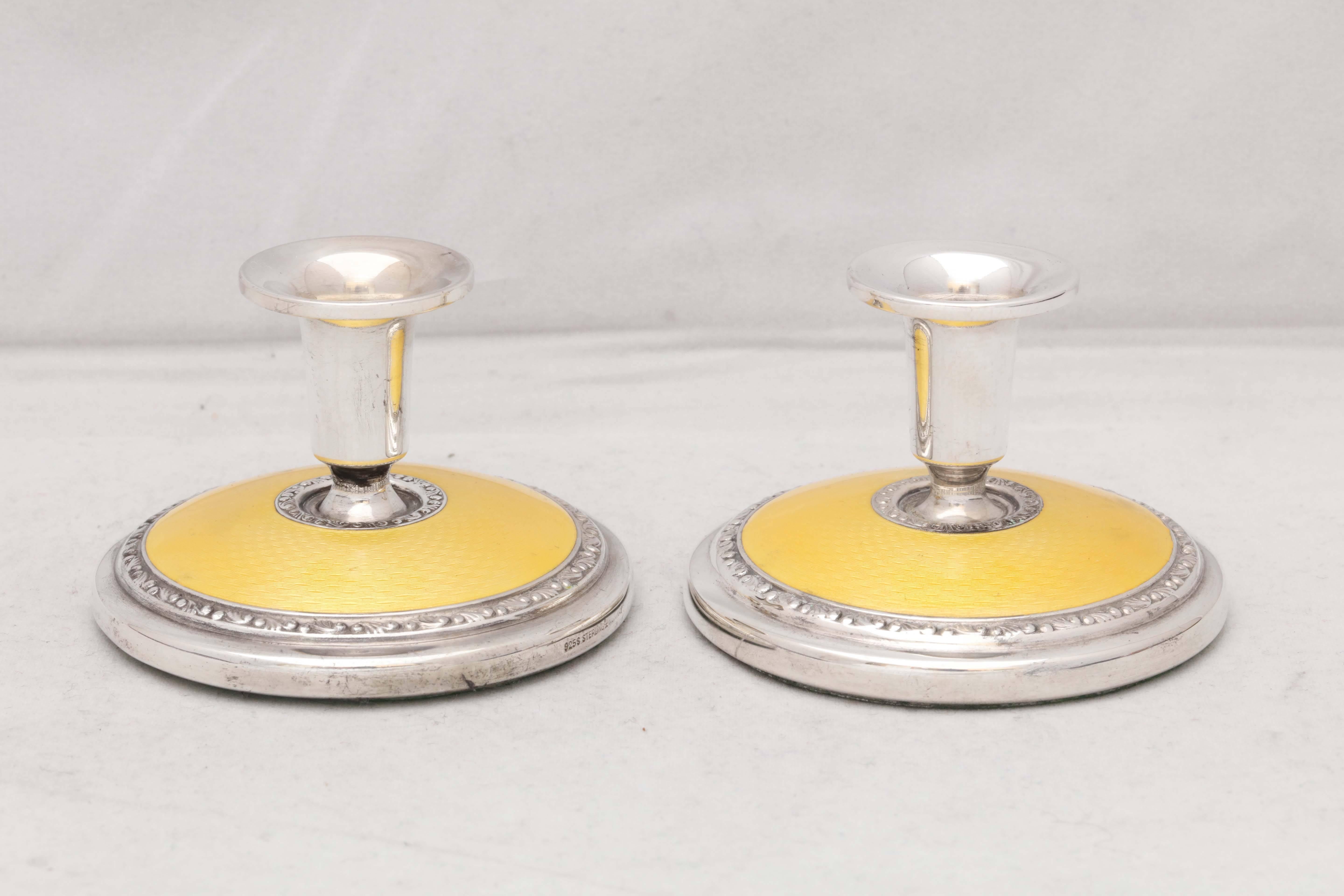 Pair of Art Deco, sterling silver and bright yellow guilloche enamel candlesticks, Norway, circa 1930s, Norsk Solwarrenindustri - makers. Measures: 2