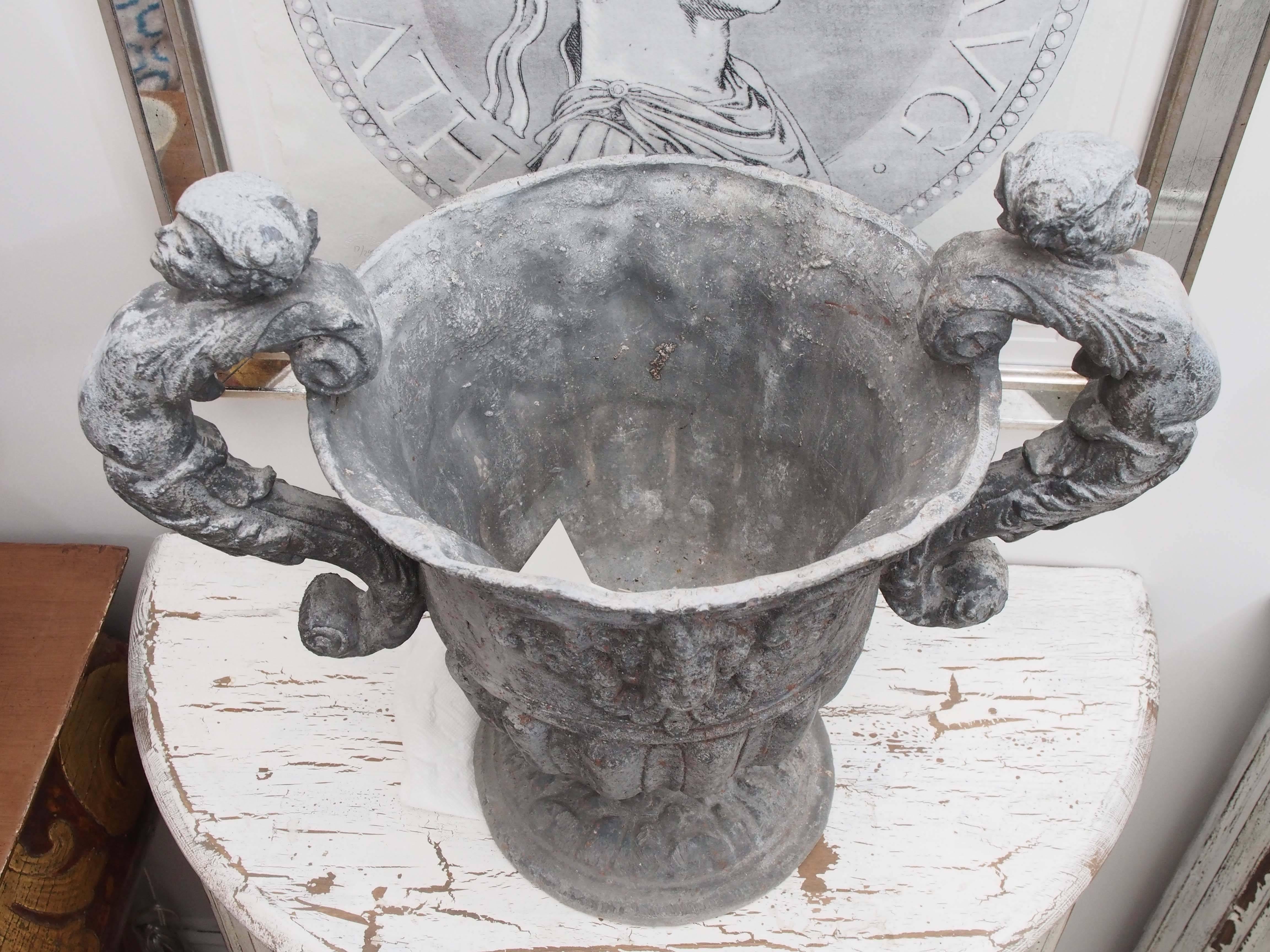 Set of Four Lead Urns with Cherubs 1