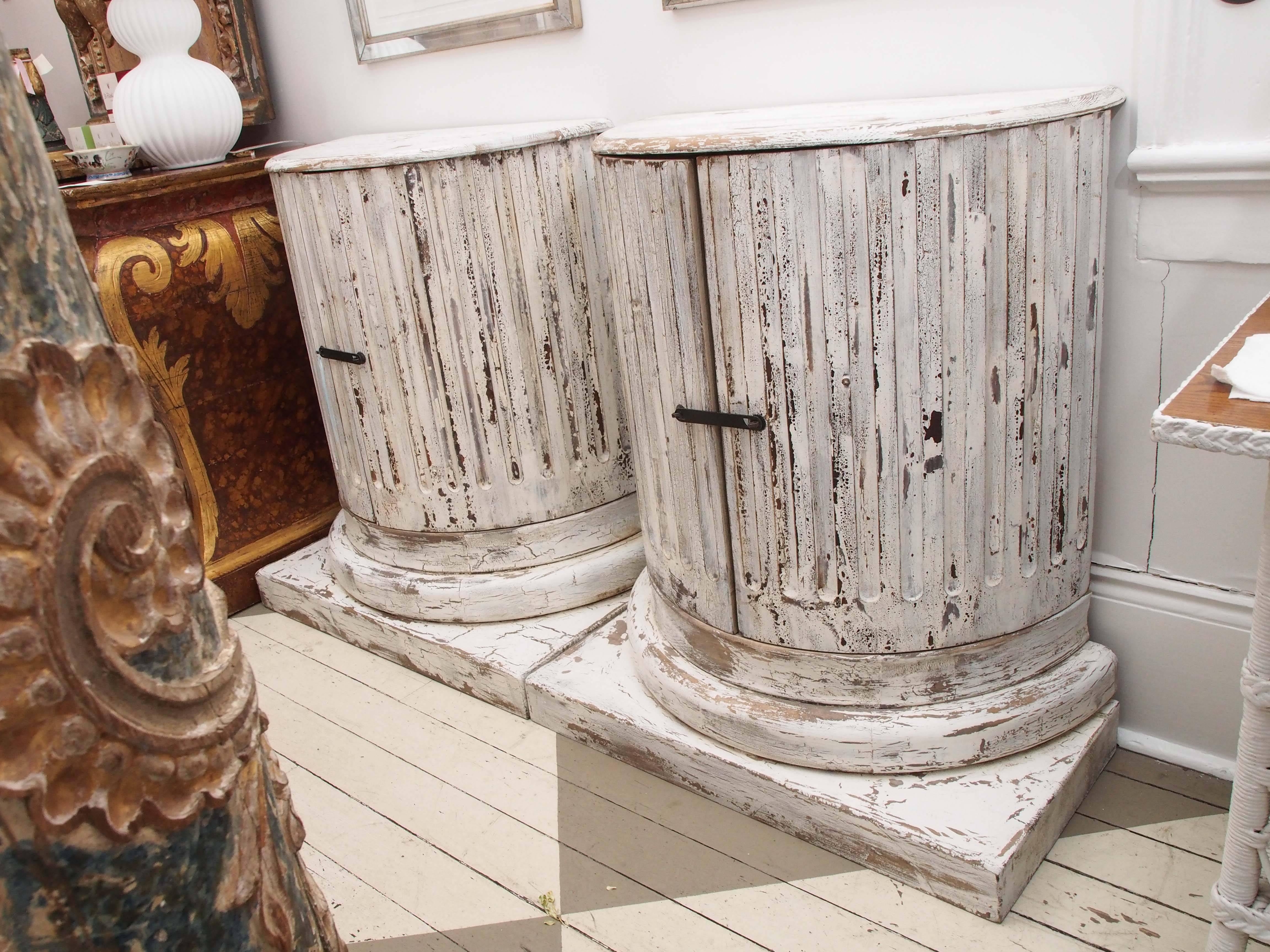 Pair of wood carved and painted column cabinets. Gorgeous patina. Unique design. Measures: Base 34 w x 16.5 deep.
    