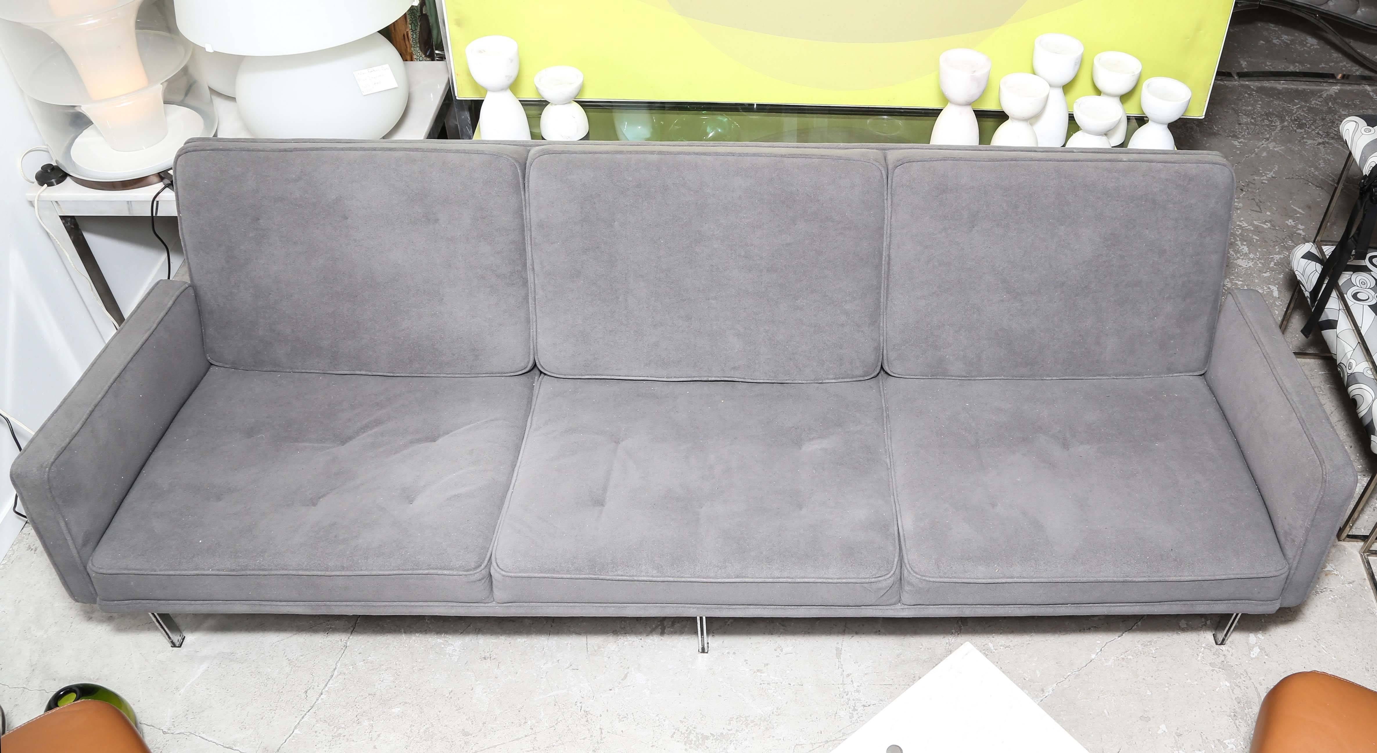 This Mid-Century Modern sofa was designed by Florence Knoll for Knoll international known as the parallel bar model 57. This is a three-seat / arm style this piece has a metal exposed frame and a upholstered wood frame seat, back and arm cushions.