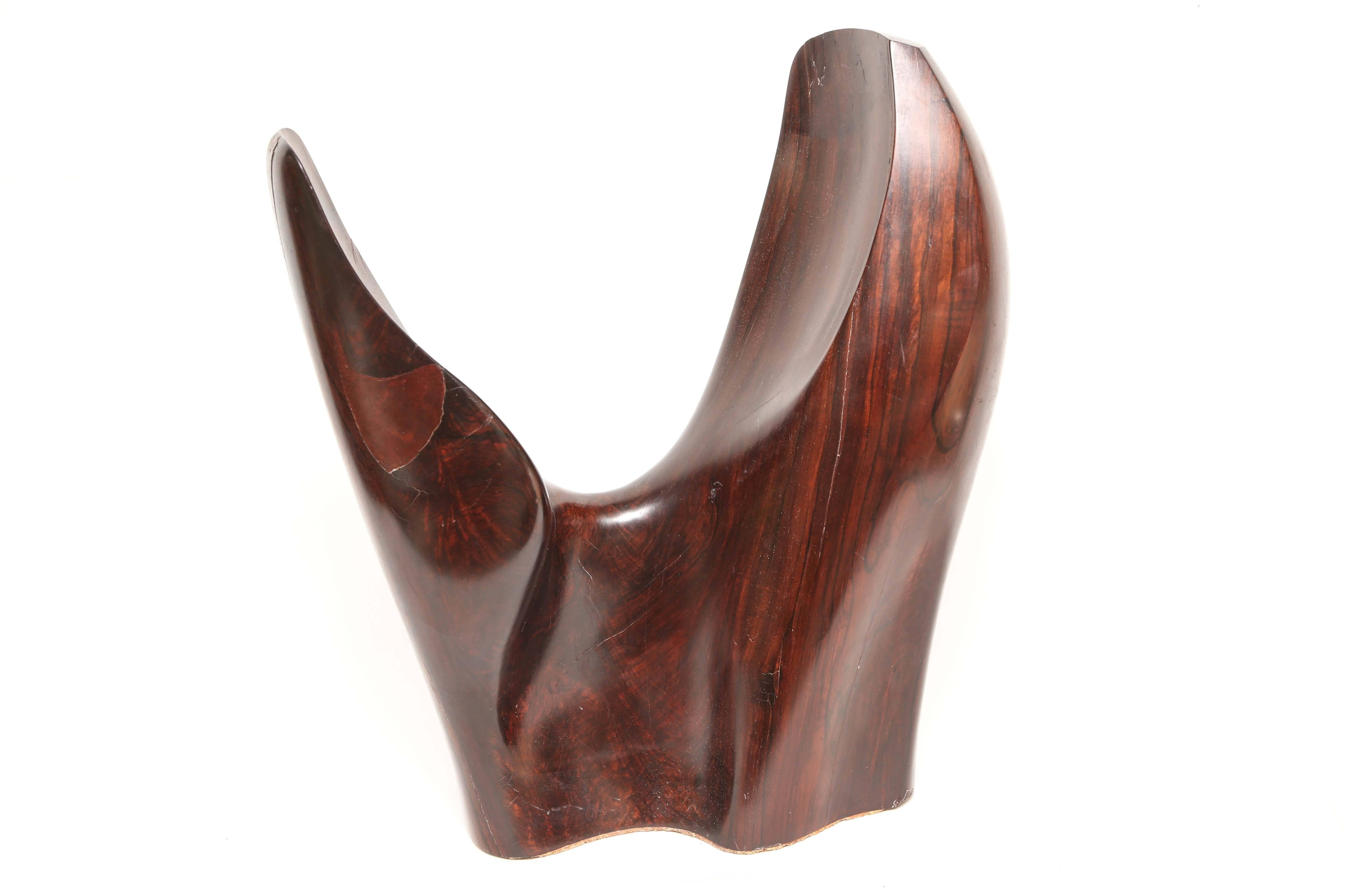 This beautiful rosewood sculpture is very much in the style of Henry Moore with its sinuous abstract shapes in a rich polished rosewood carving and though not signed or couldn't find signature you could tell a master sculptor put his talent into