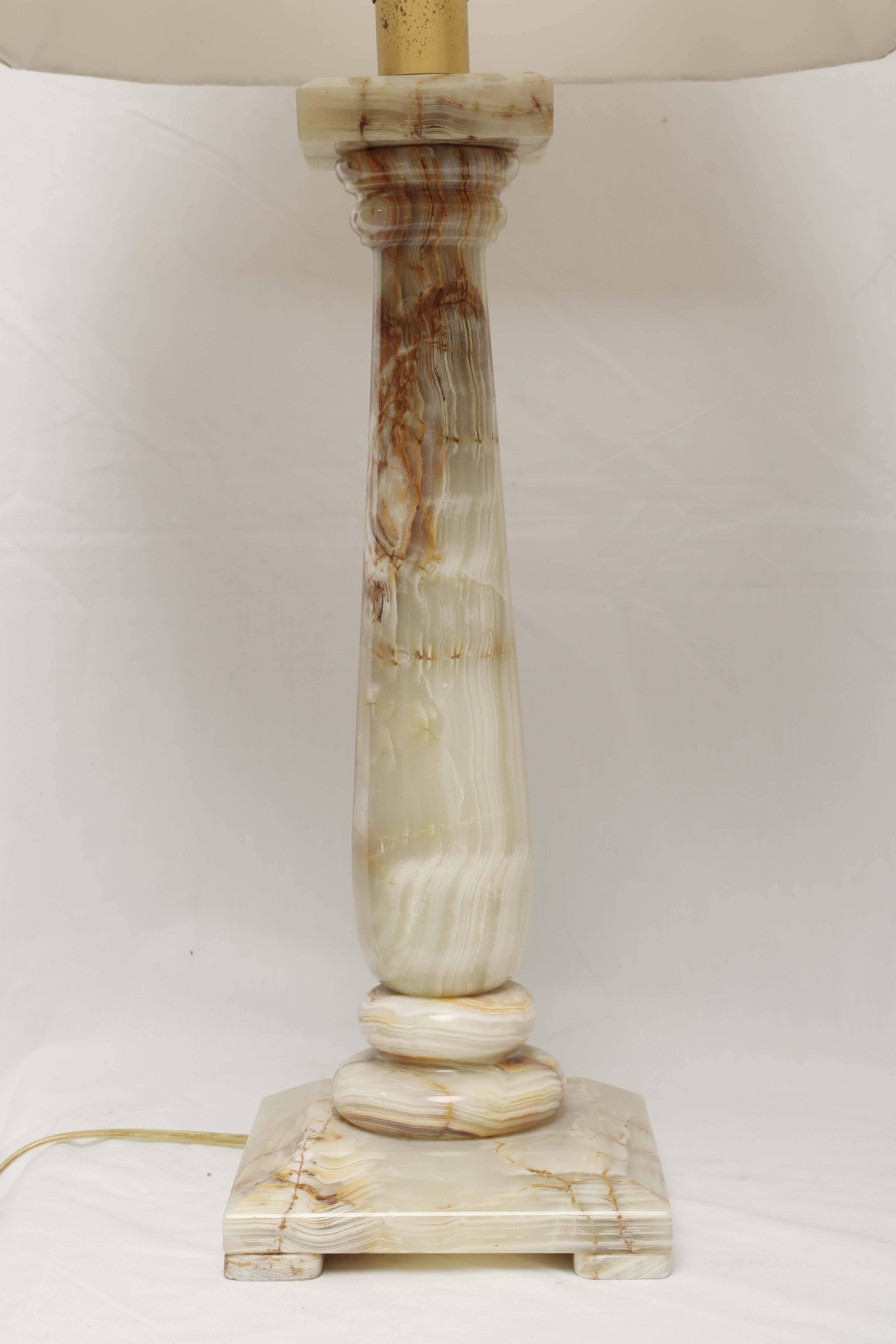 These lamps have a timeless style to them, probably Italian in origin they could either work in a mid century modern aesthetic or a very regal Hollywood regency set up. Made of beautiful onyx stone with lots of veining and color. Done in a