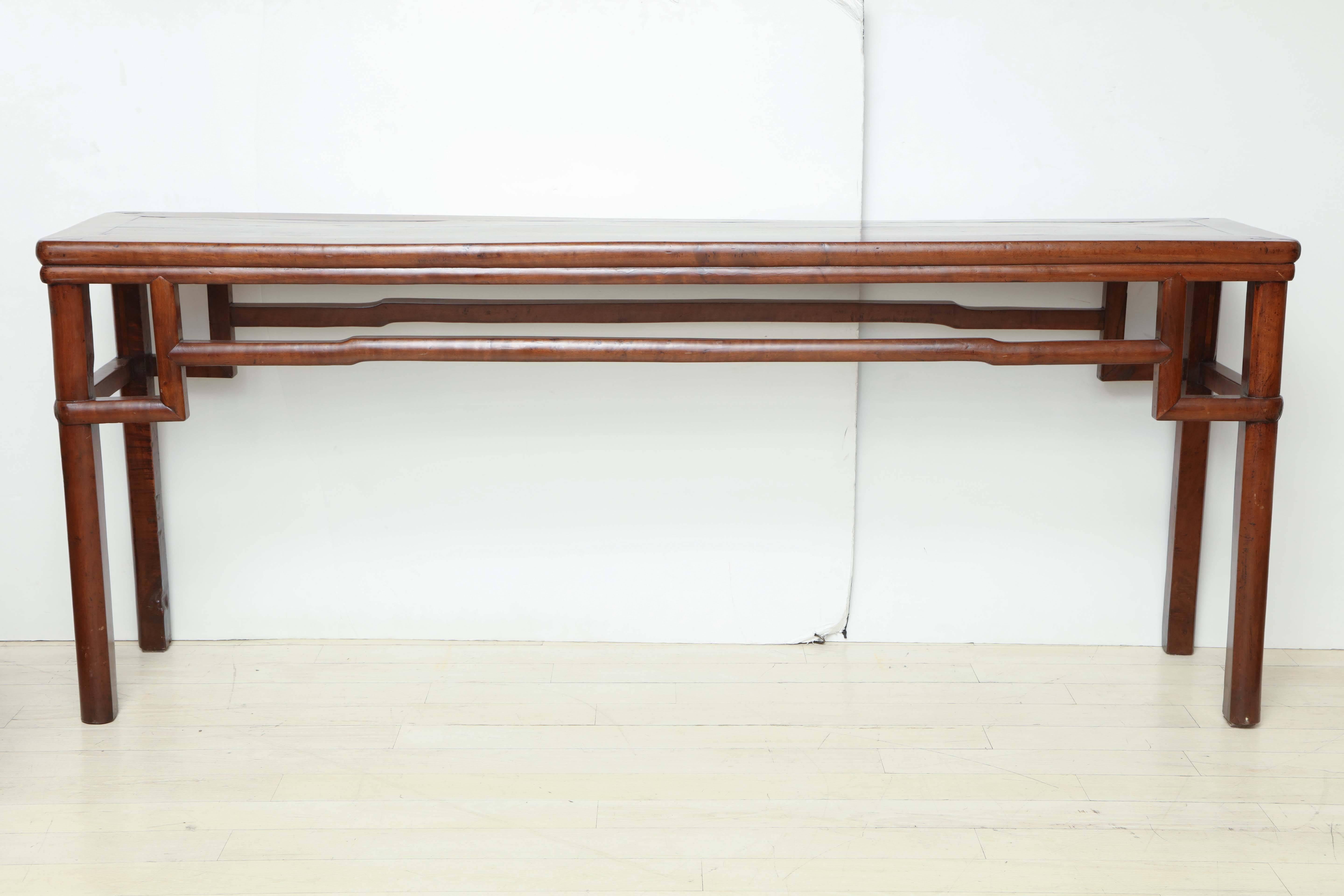 Early 19th century walnut console table with shaped stretcher.

Overall dimensions:
78.5” W, 16.5” D, 32” H.