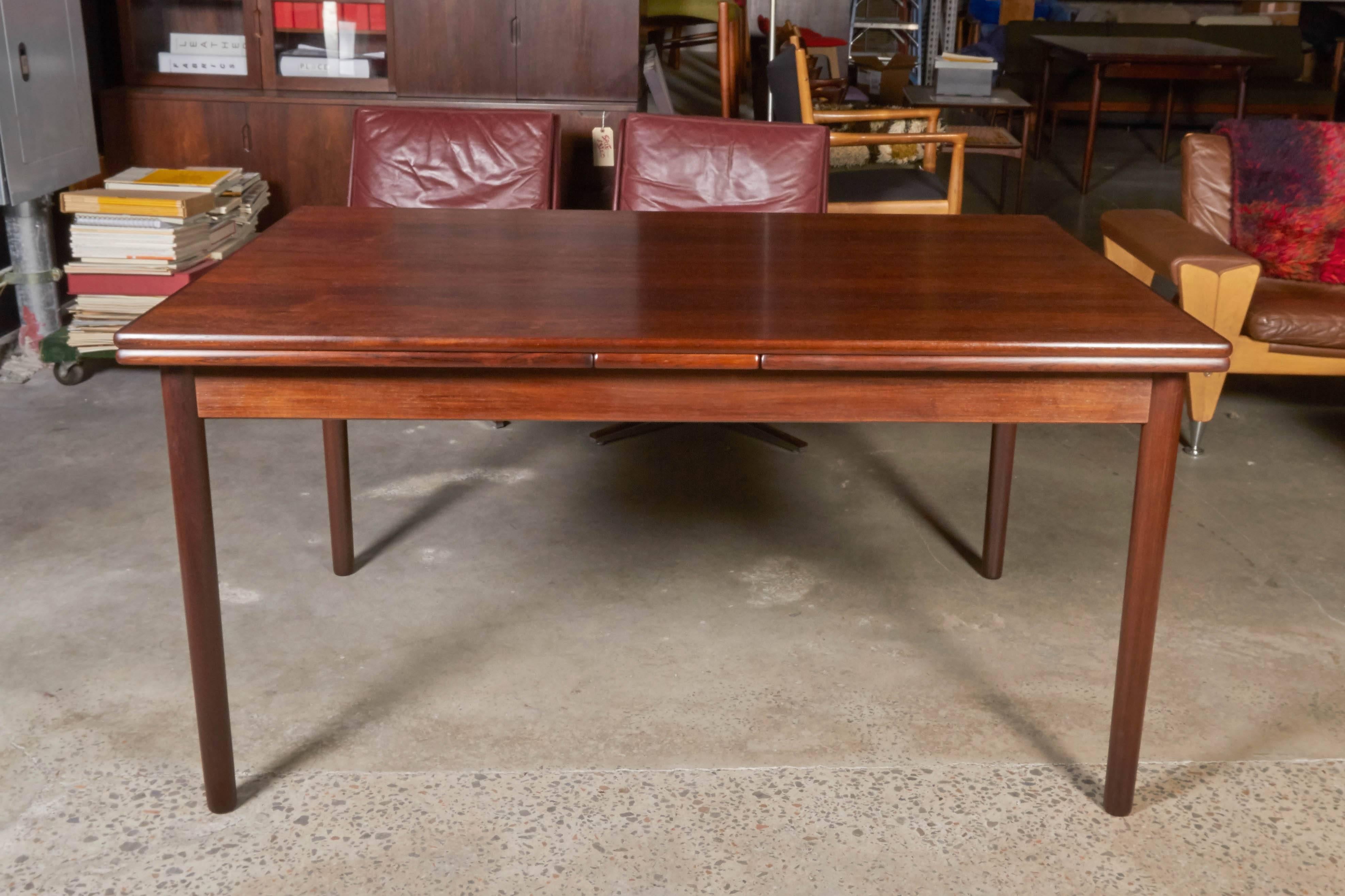 Vintage 1960s Danish Modern Dining Table

This expandable dining room table is excellent condition. The leaves site underneath each side of the table and easily slide out when they are needed. Each leaf is 22.5" wide and when pulled out can