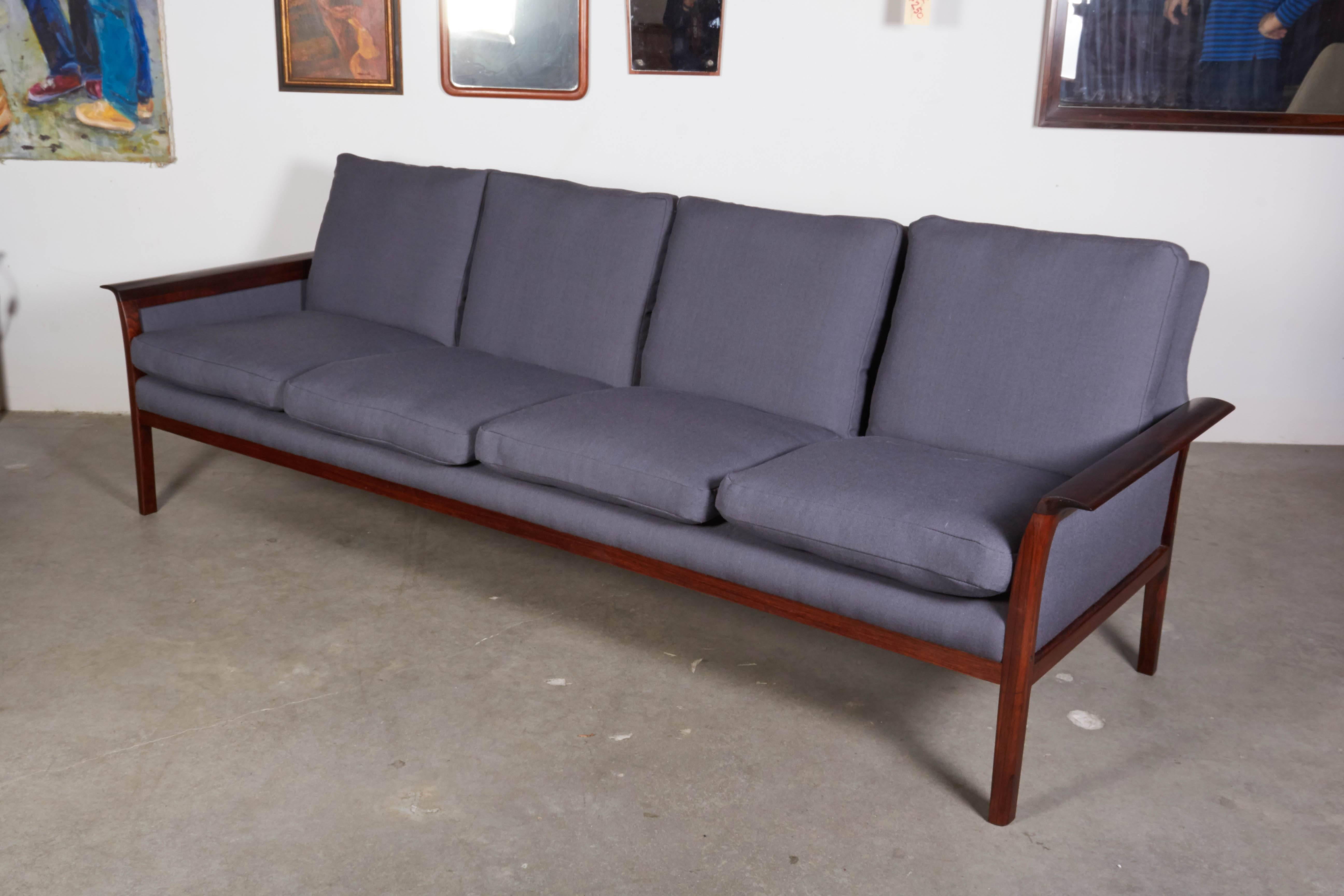 Vintage 1960s Rosewood Sofa by Knut Saeter 

This grey or blue sofa is made up of a rosewood frame and feather and down cushions. Nice shallow depth yet very comfortable. Each cushion is more like a pillow. We upholstered it in a wool blend or for
