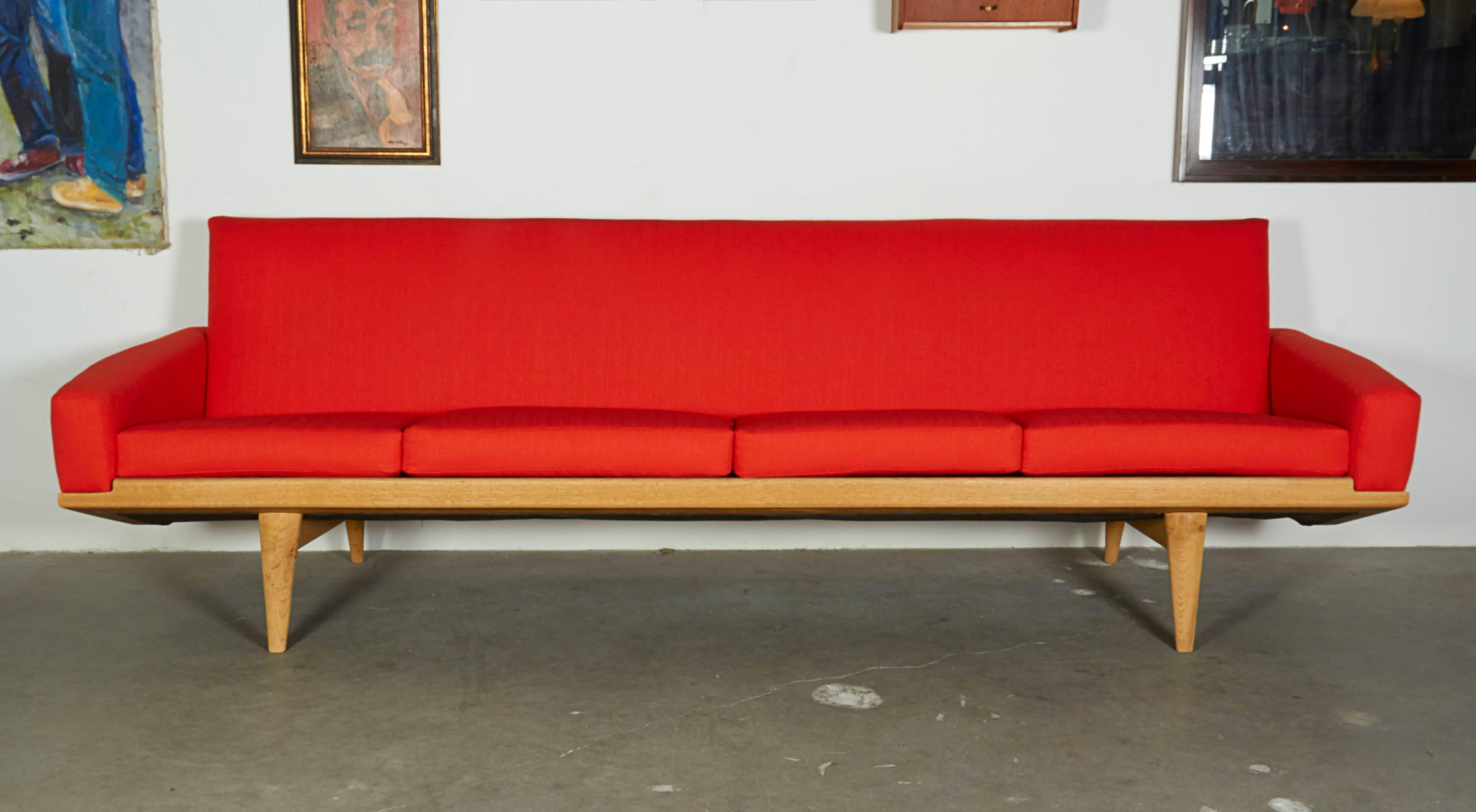 Vintage 1950s Danish Retro Orange Four-Seat Sofa Produced by N. A. Jørgensens Møbelfabrik.

This electric orange sofa is the best thing you'll see all day! Oak frame in like new condition and newly upholstered. Fabric is a re-issue from the late