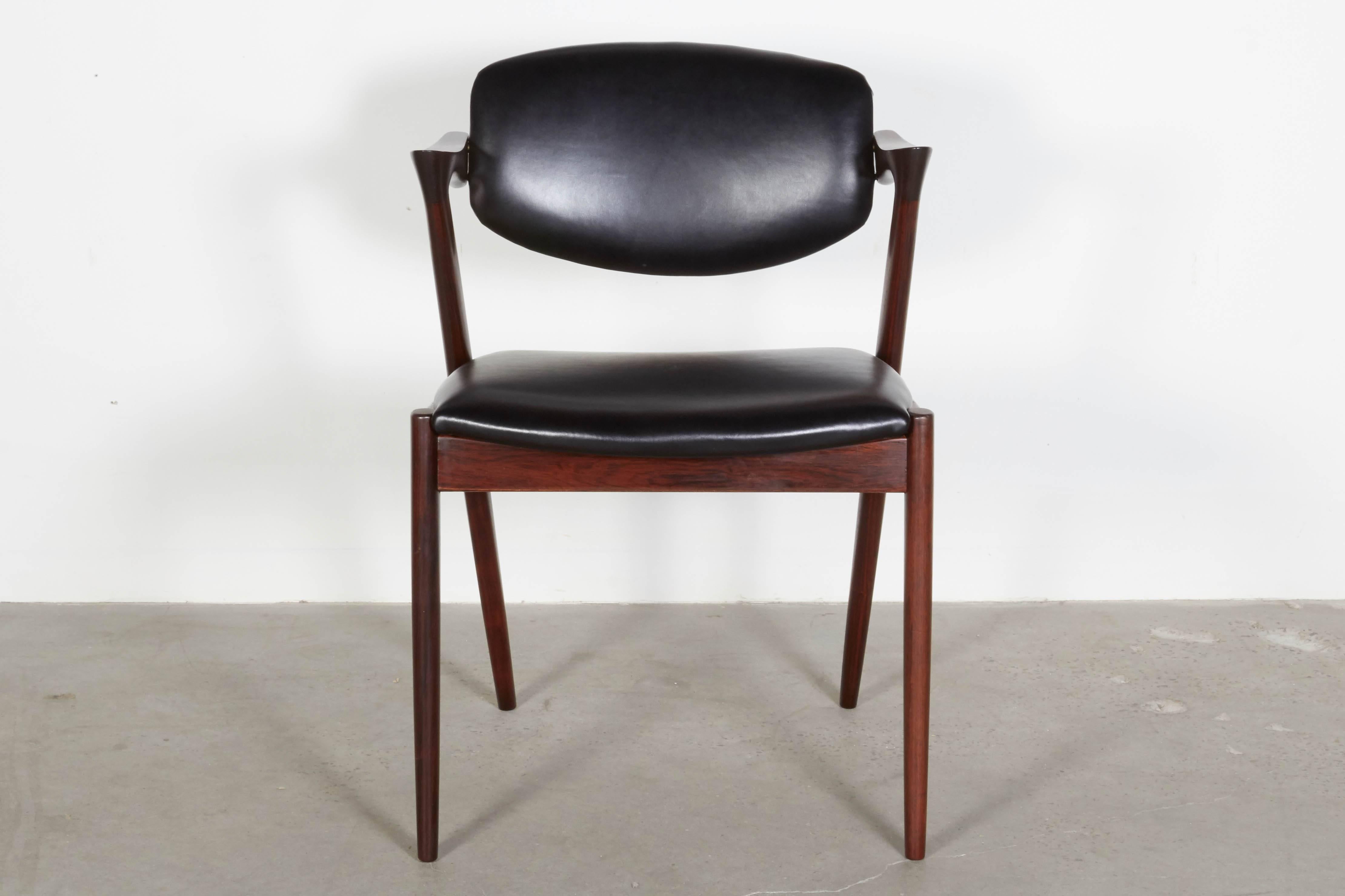 Vintage 1950s Rosewood Danish Dining Chairs by Kai Kristiansen

These Mid-Century side chairs are in like-new condition. The swivel back that adjusts to the angle of your back makes it like a little lounge chair at the dining table. The most