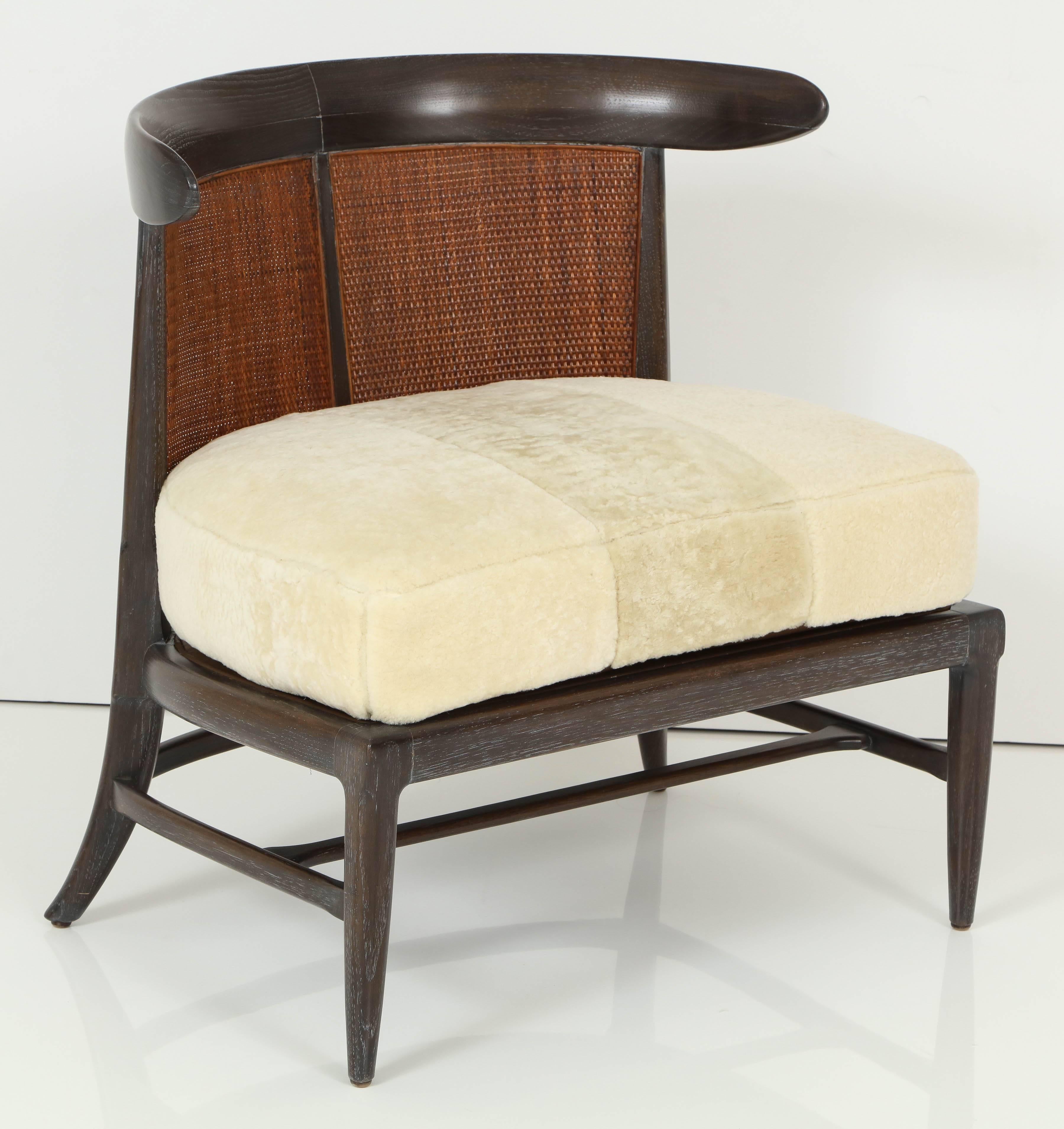 Tomlinson slipper chair, circa 1950. With coffee ceruse finish, natural rattan and upholstered in shearling.