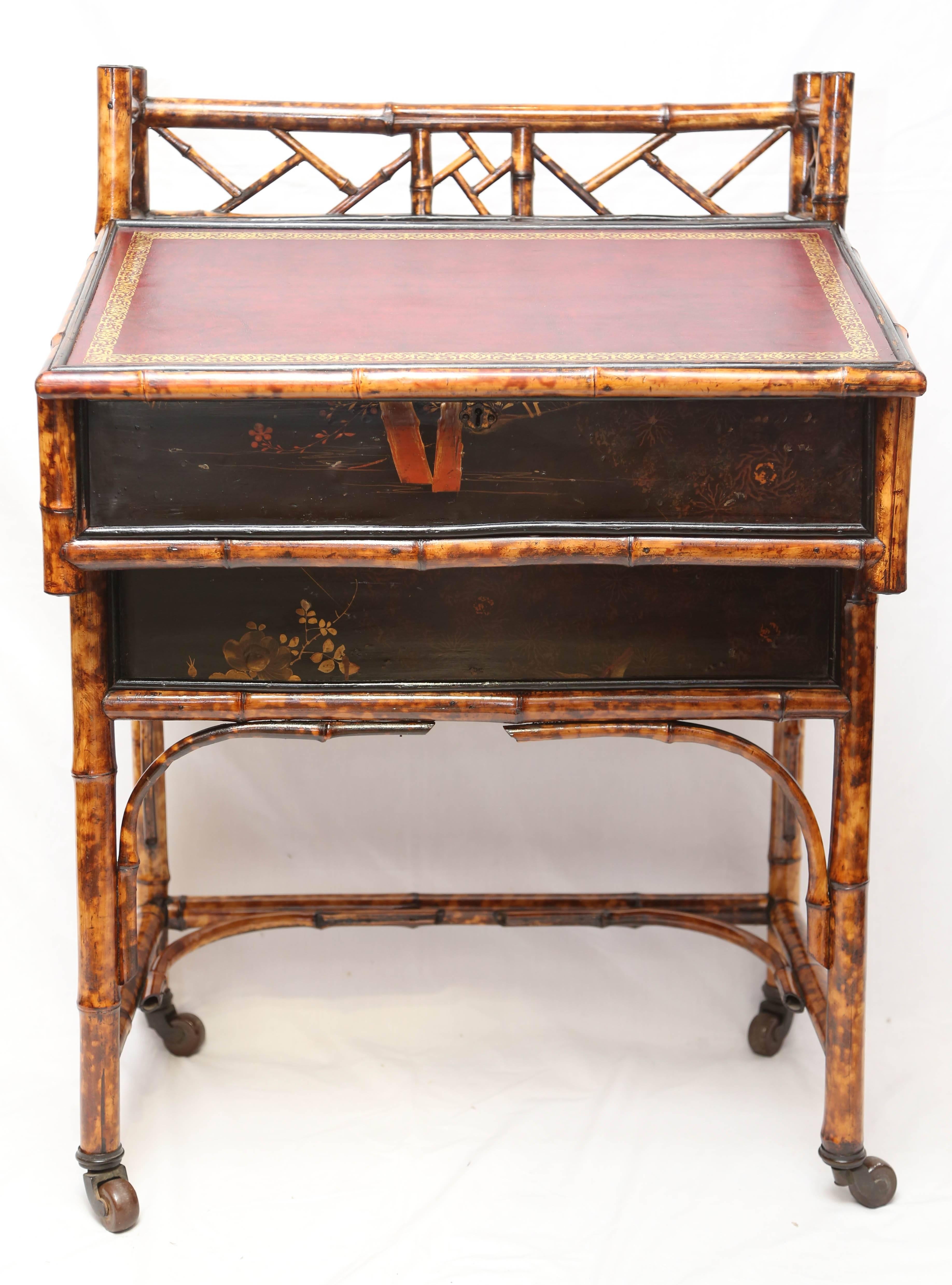 A beautiful 19th century English bamboo desk with a compartment for storage enclosed by a leather clad front lid, two short drawers in case, bamboo legs connected by stretchers, brass casters.
 
 
