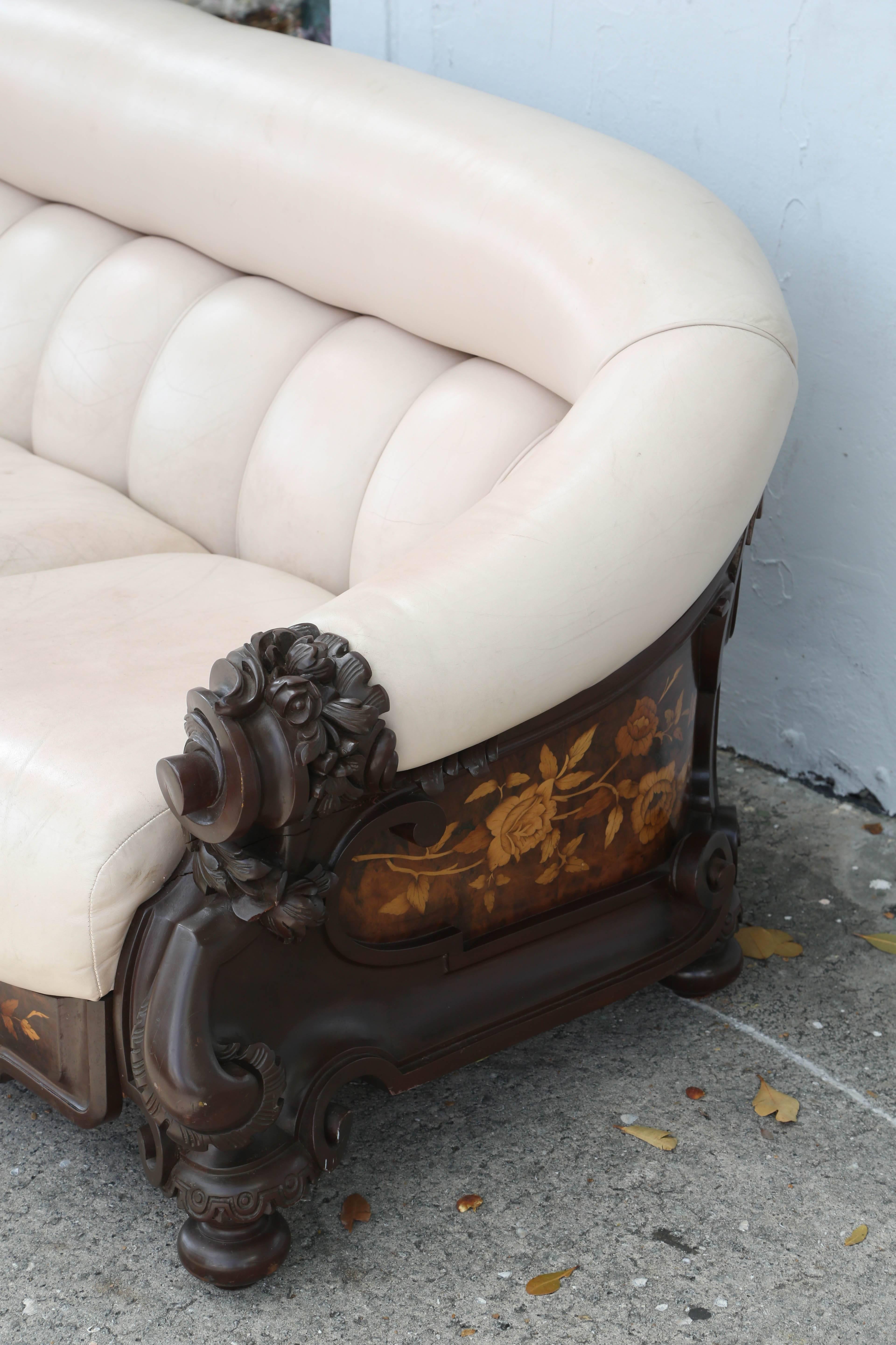 This is a very nice heavy duty leather Settee with mahogany frame, it also has satinwood marquetry to the sides and front.
Exceptional in every detail, sumptuous leather, dramatic inlays and generous scale, late 19th century Nouveau