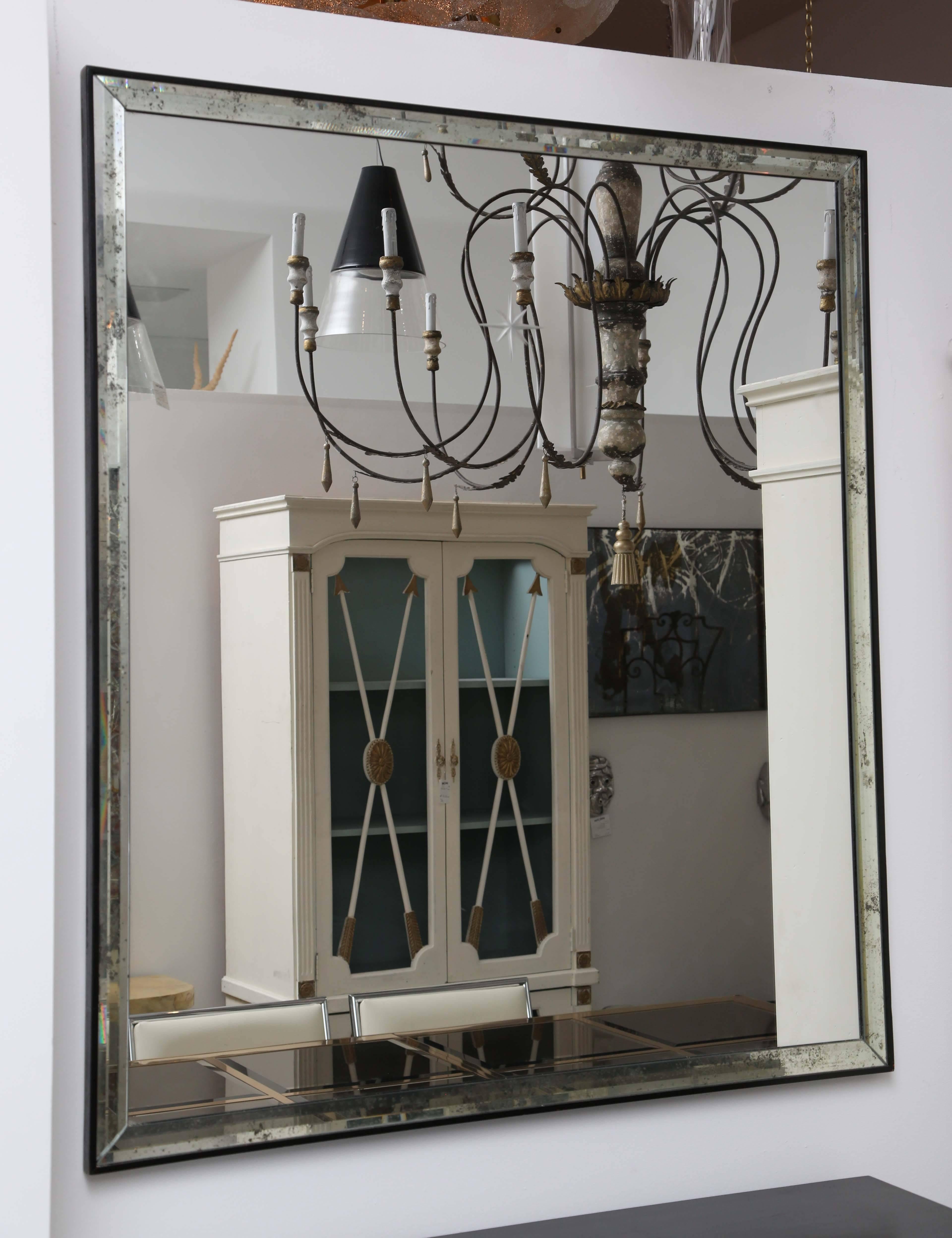 Pair of mirrors with mercury glass edge and central star motif.